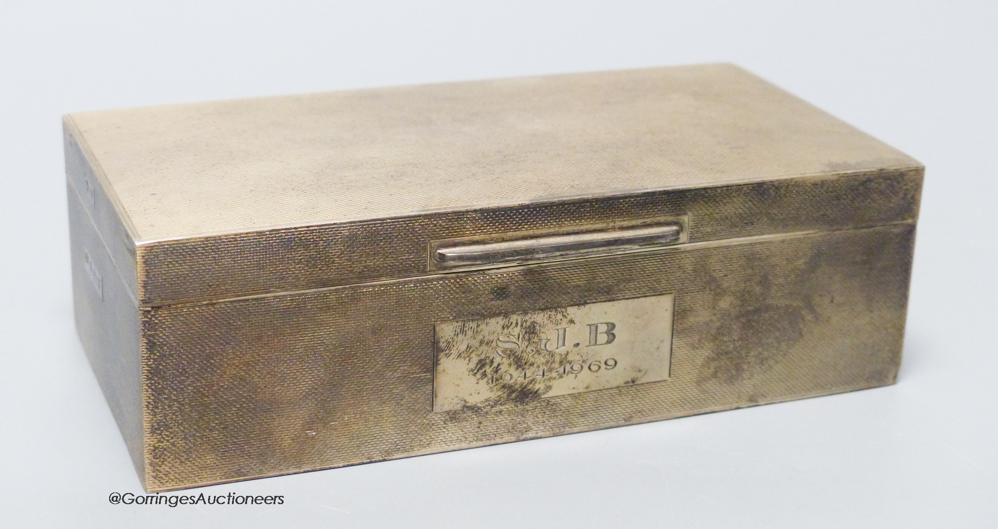 A late 1960's engine turned rectangular silver cigarette box, by Mappin & Webb, Birmingham, 1968, 16.6cm, gross 16.5oz.                                                                                                     