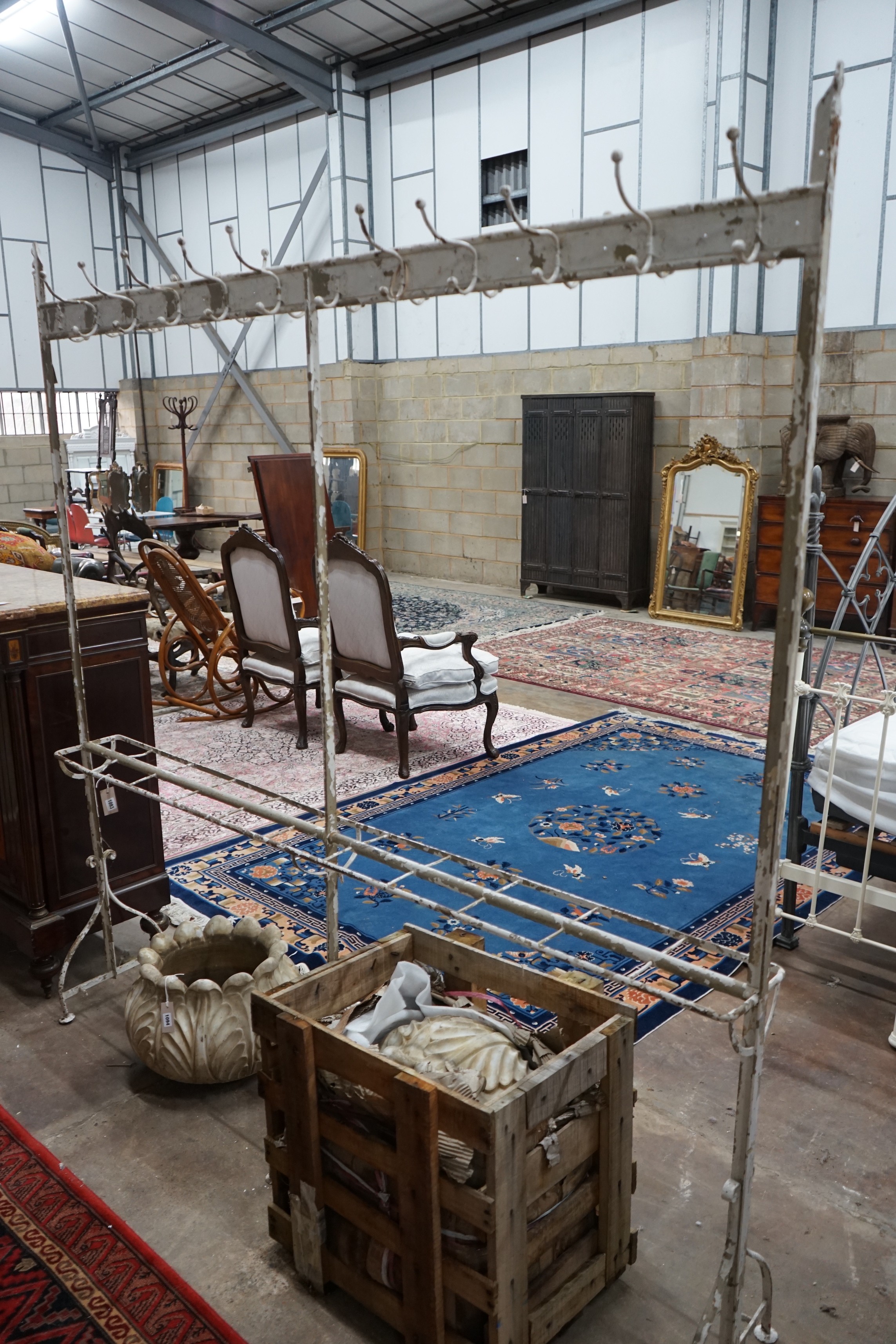 A vintage wrought iron coat and stick stand, width 200cm, height 206cm                                                                                                                                                      