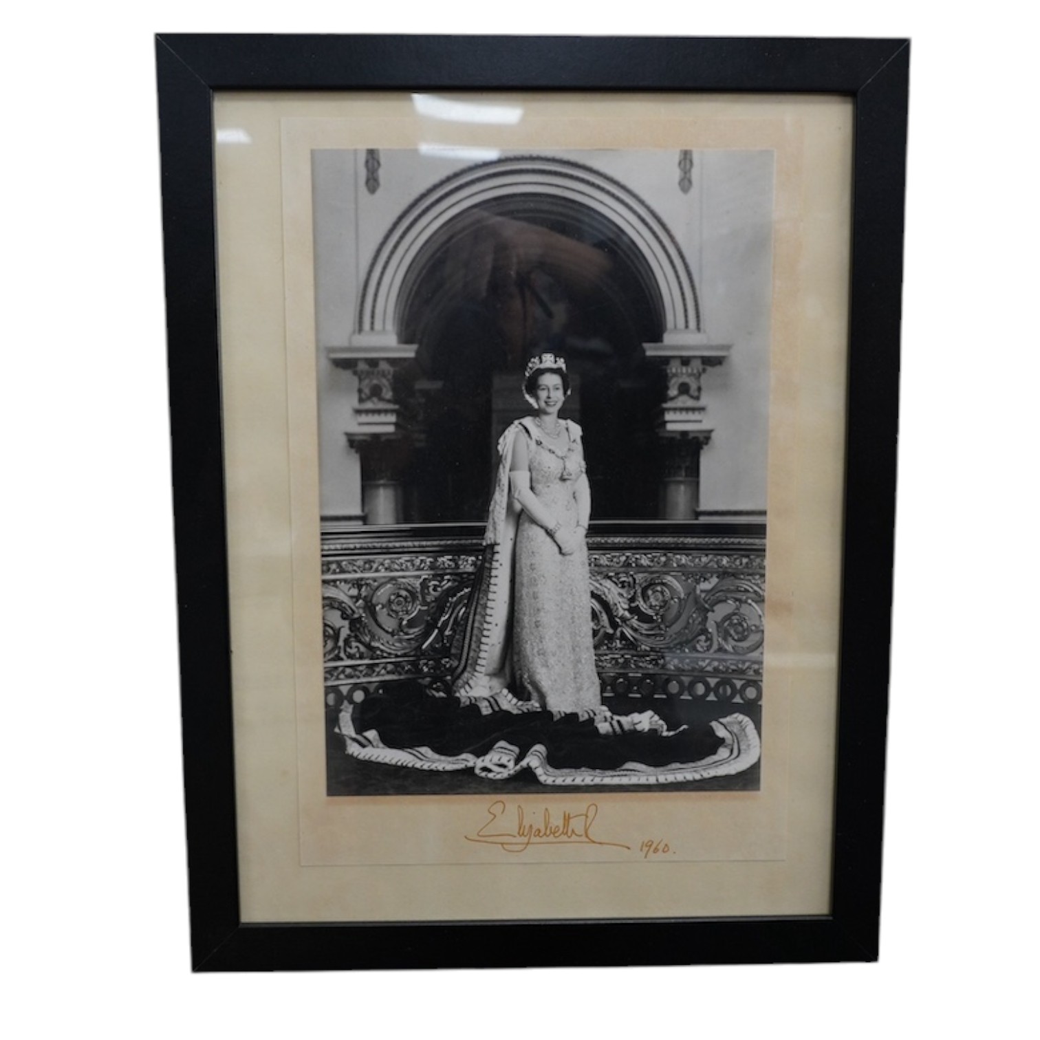 A signed photograph of Queen Elizabeth II, dated 1960 and issued for display in a British Embassy overseas, signed in the mount, 30 x 20.5cm. Condition - good                                                              