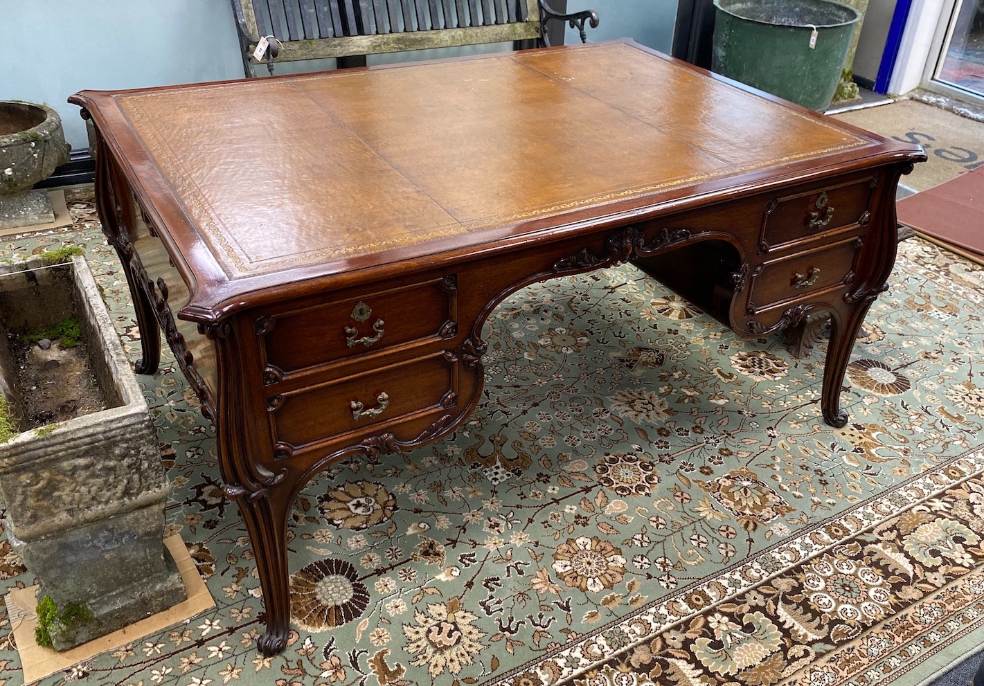 An early 20th century mahogany kneehole partner's desk with tooled tan leather inset top, length 154cm, depth 110cm, height 73cm                                                                                            