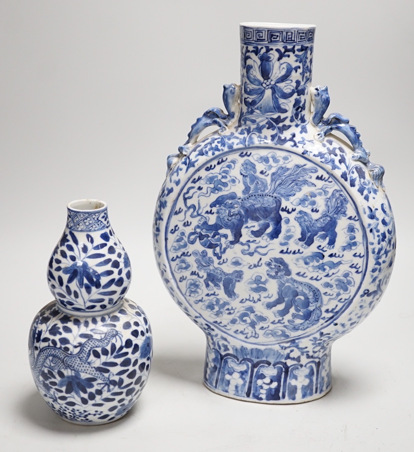 A Chinese blue and white moonflask and a similar double gourd vase, 19th century, moon flask 31cms high                                                                                                                     