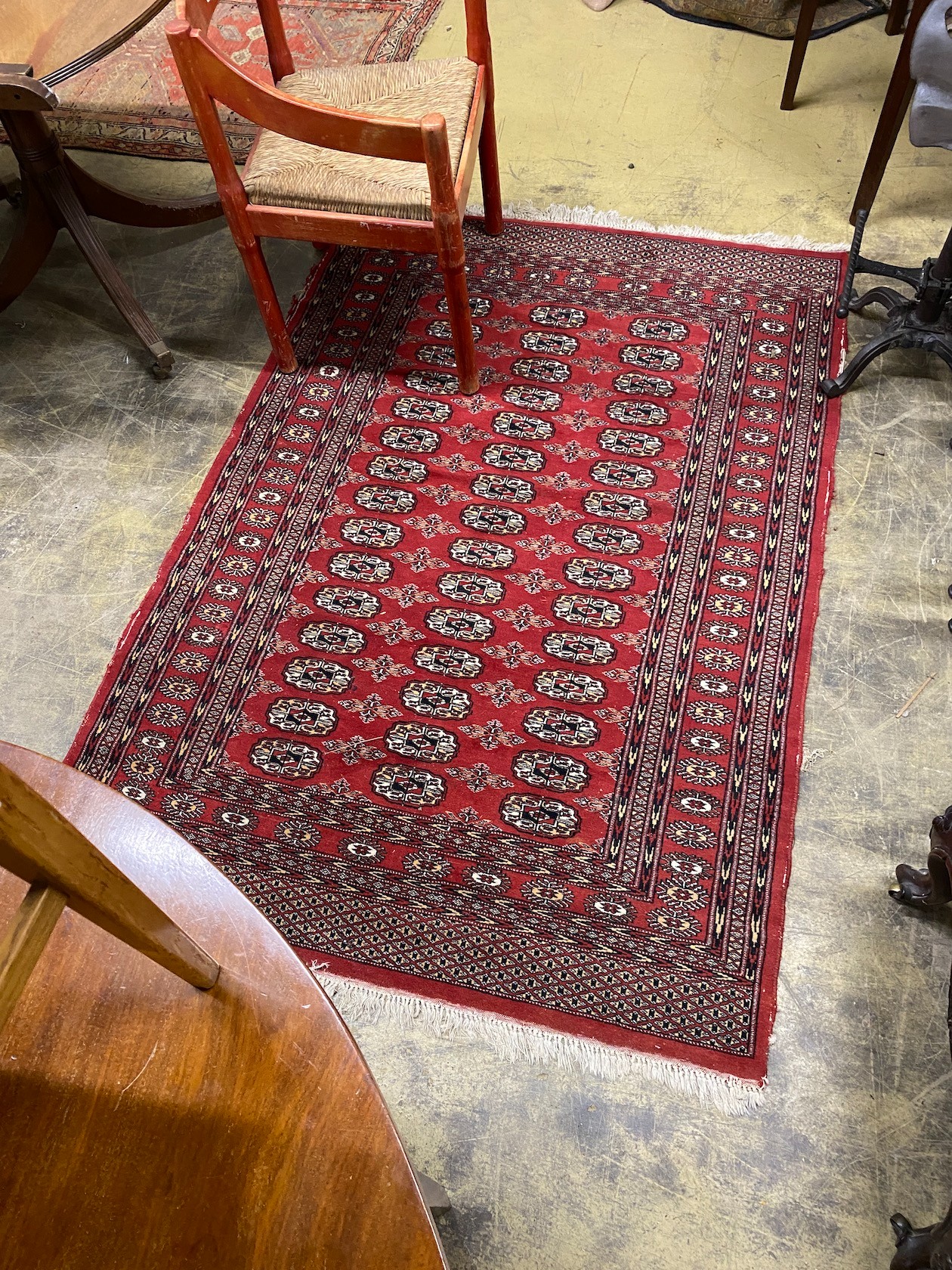 A Bokhara red ground rug, 186 x 126cm                                                                                                                                                                                       