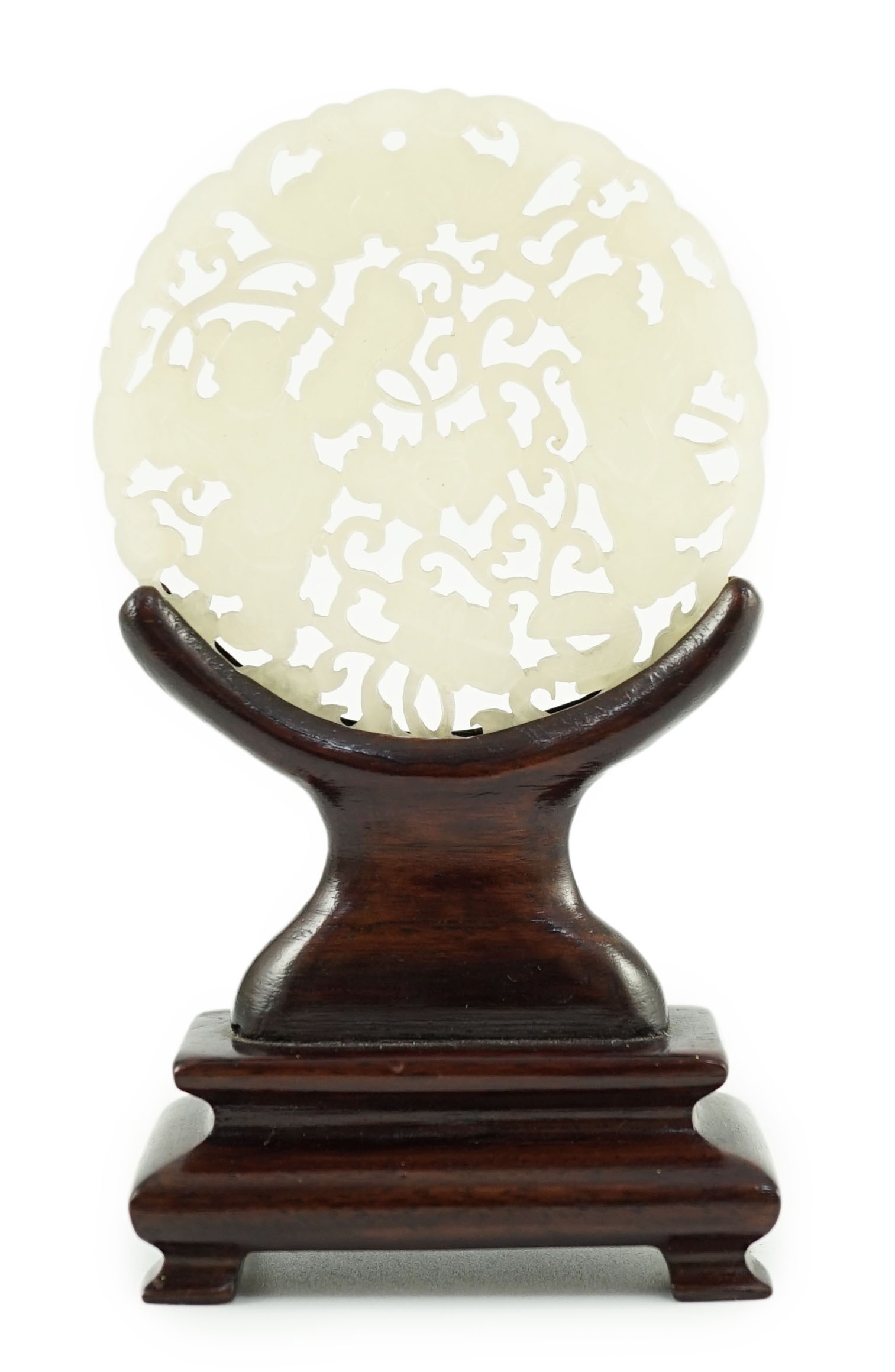 A Chinese white jade ‘Hehe Erxian’ disc, 19th/20th century, 5.6cm diameter, wood stand                                                                                                                                      