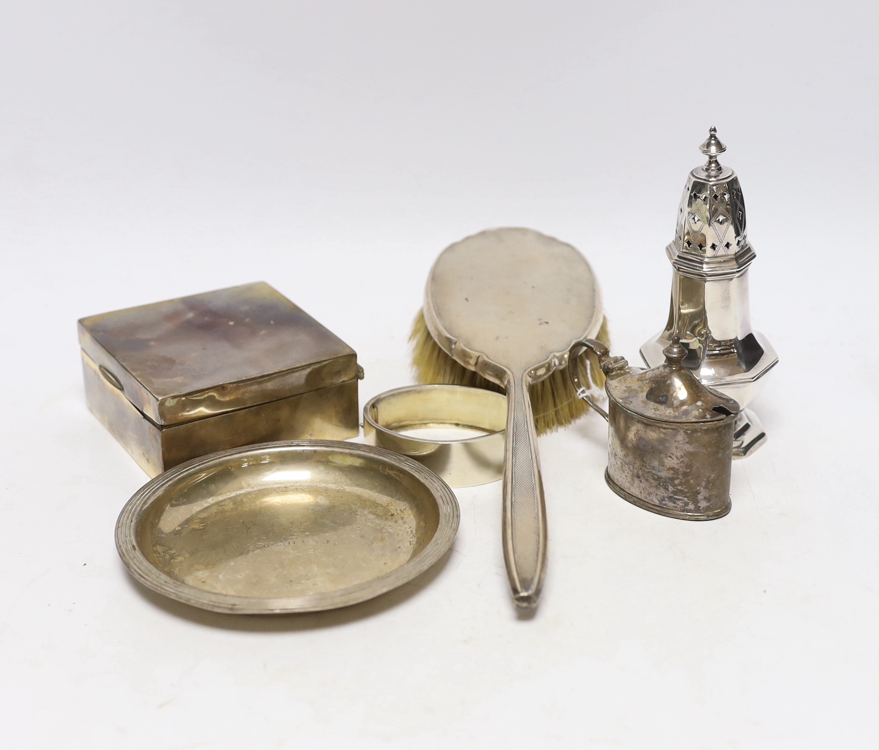 Sundry silver including a mounted hair brush, cigarette box, small dish, bangle, caster and mustard.                                                                                                                        