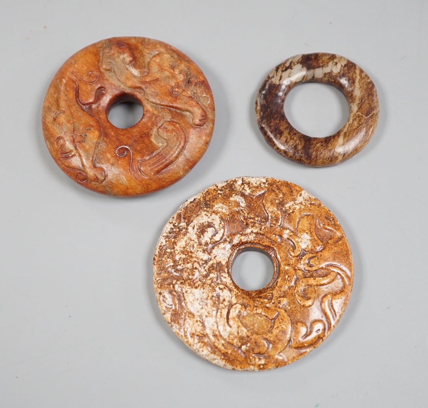 Three Chinese jade or hardstone roundels                                                                                                                                                                                    