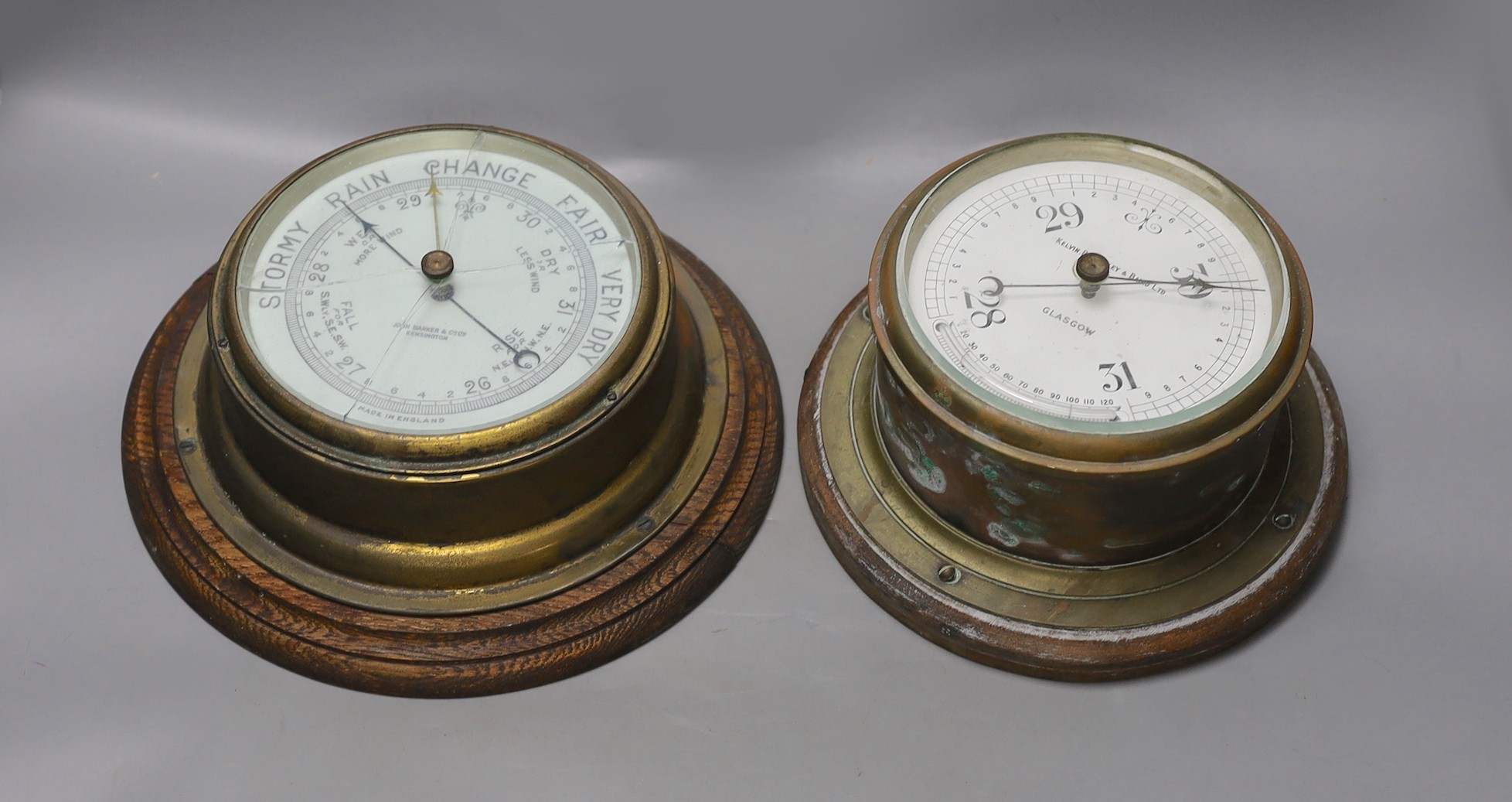 A John Barker & co brass bulkhead barometer and another by Kelvin Bottomly & Baird ltd., diameter 27. 5 cm                                                                                                                  