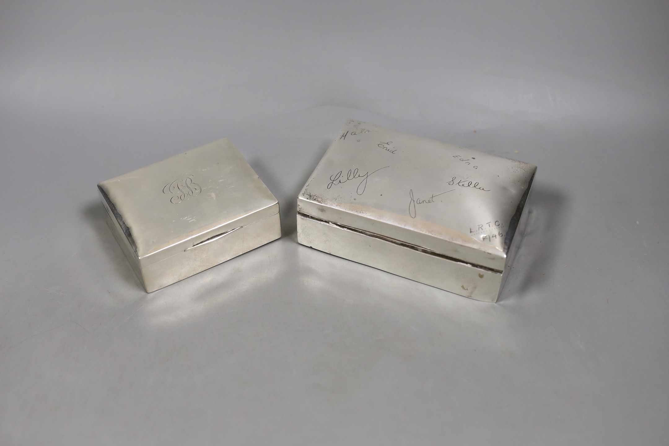 A George V silver mounted cigarette box, William Hutton & Sons, Birmingham, 1917, 89mm and a later larger Egyptian white metal cigarette box.                                                                               