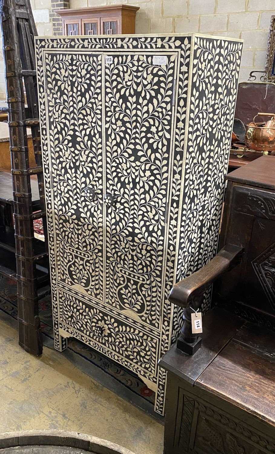 A modern Indian faux ivory inlaid ebonised two door cabinet, width 71cm, depth 35cm, height 152cm                                                                                                                           