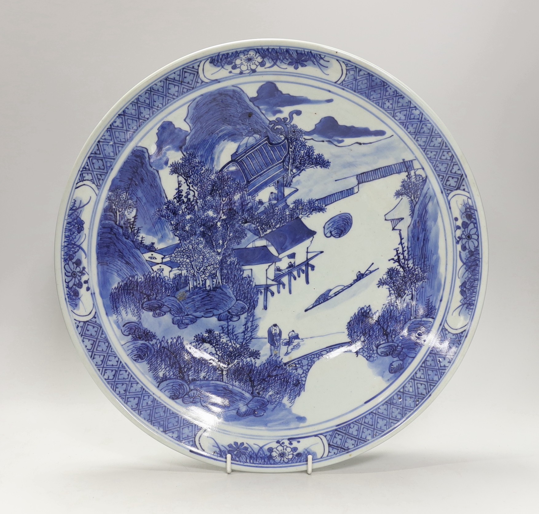A 19th century Chinese blue and white landscape dish. 38cm diameter                                                                                                                                                         