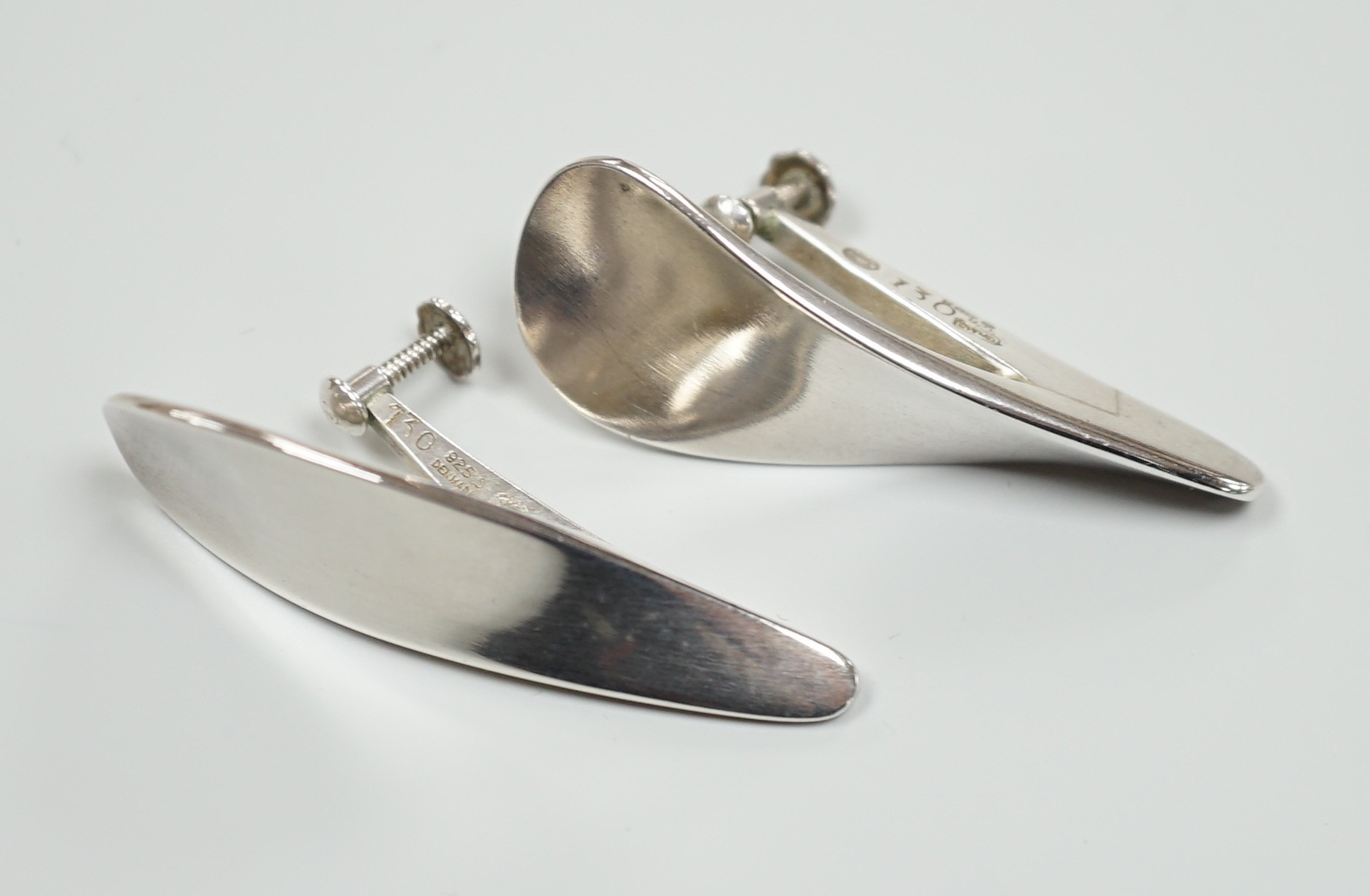 A pair of 1970's silver Georg Jensen curved teardrop shaped ear clips, design no. 130, 40mm.                                                                                                                                