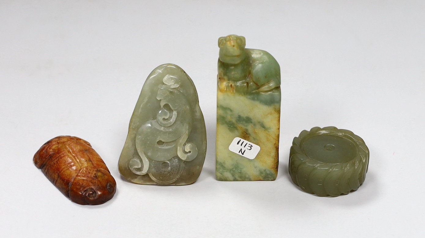 A Chinese green jade 'cash' wheel and a russet jade cicada, a jade pebble carving and a hardstone seal                                                                                                                      