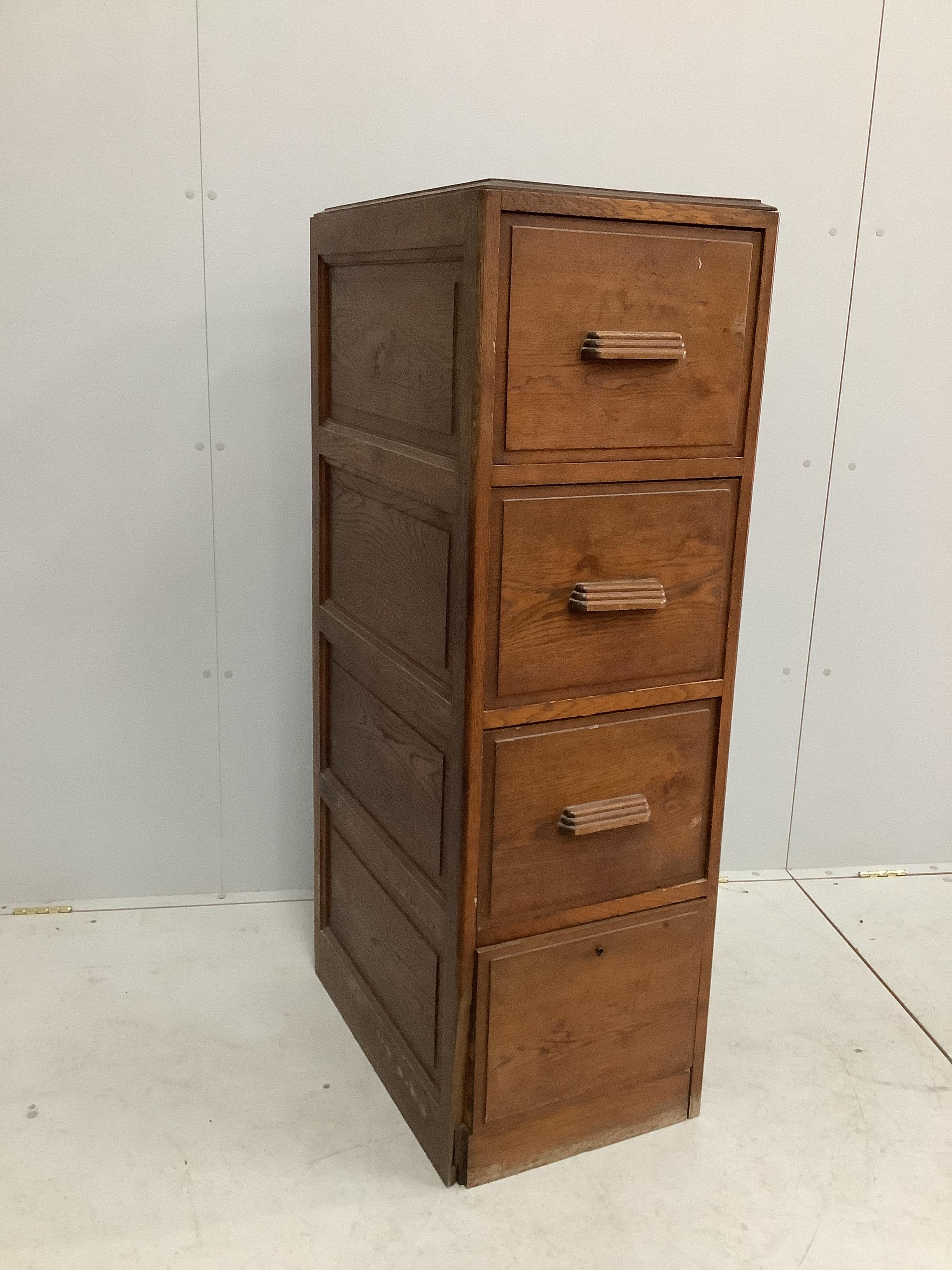 An early 20th century oak four drawer filing cabinet, width 41cm, depth 60cm, height 130cm                                                                                                                                  