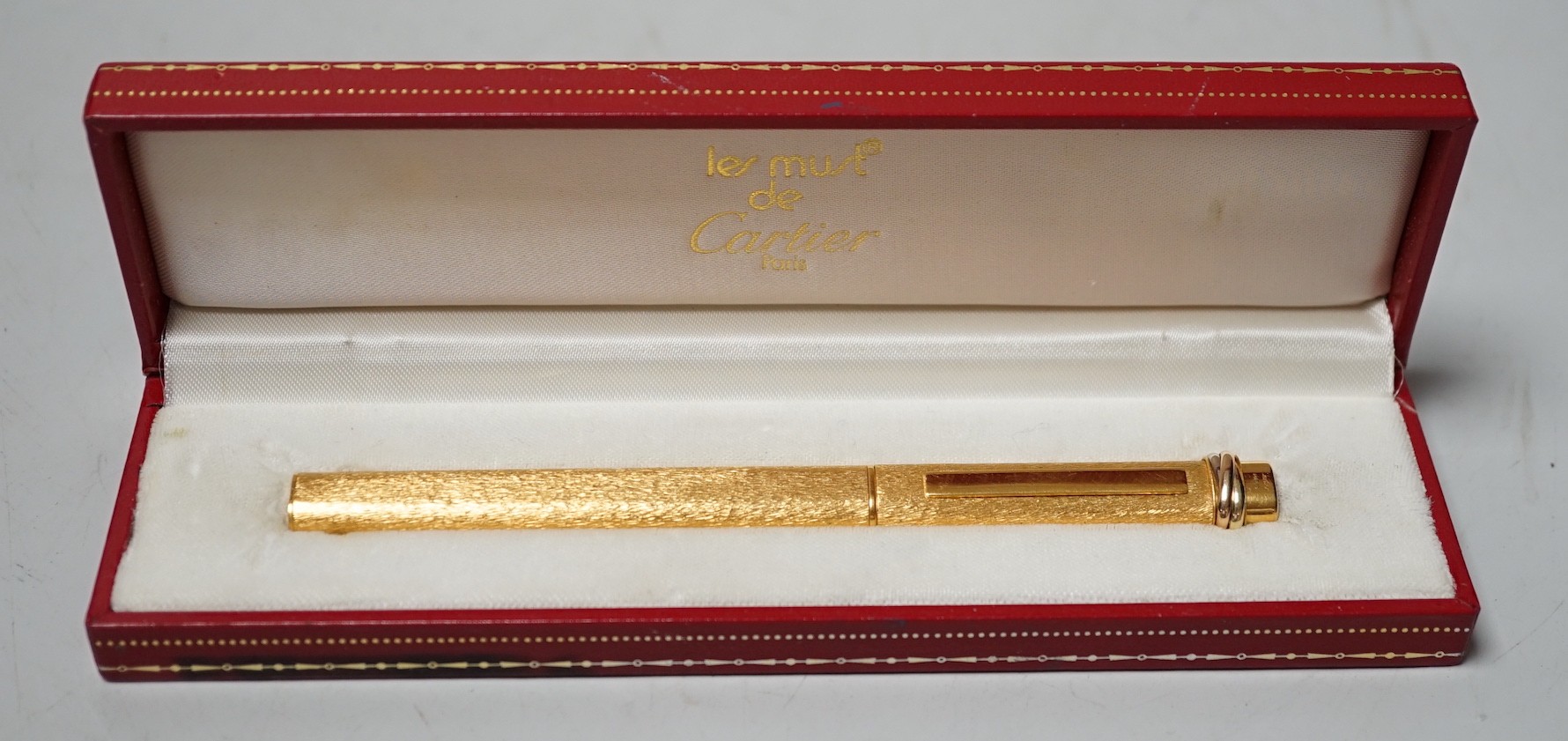 A boxed Must De Cartier ballpoint pen                                                                                                                                                                                       