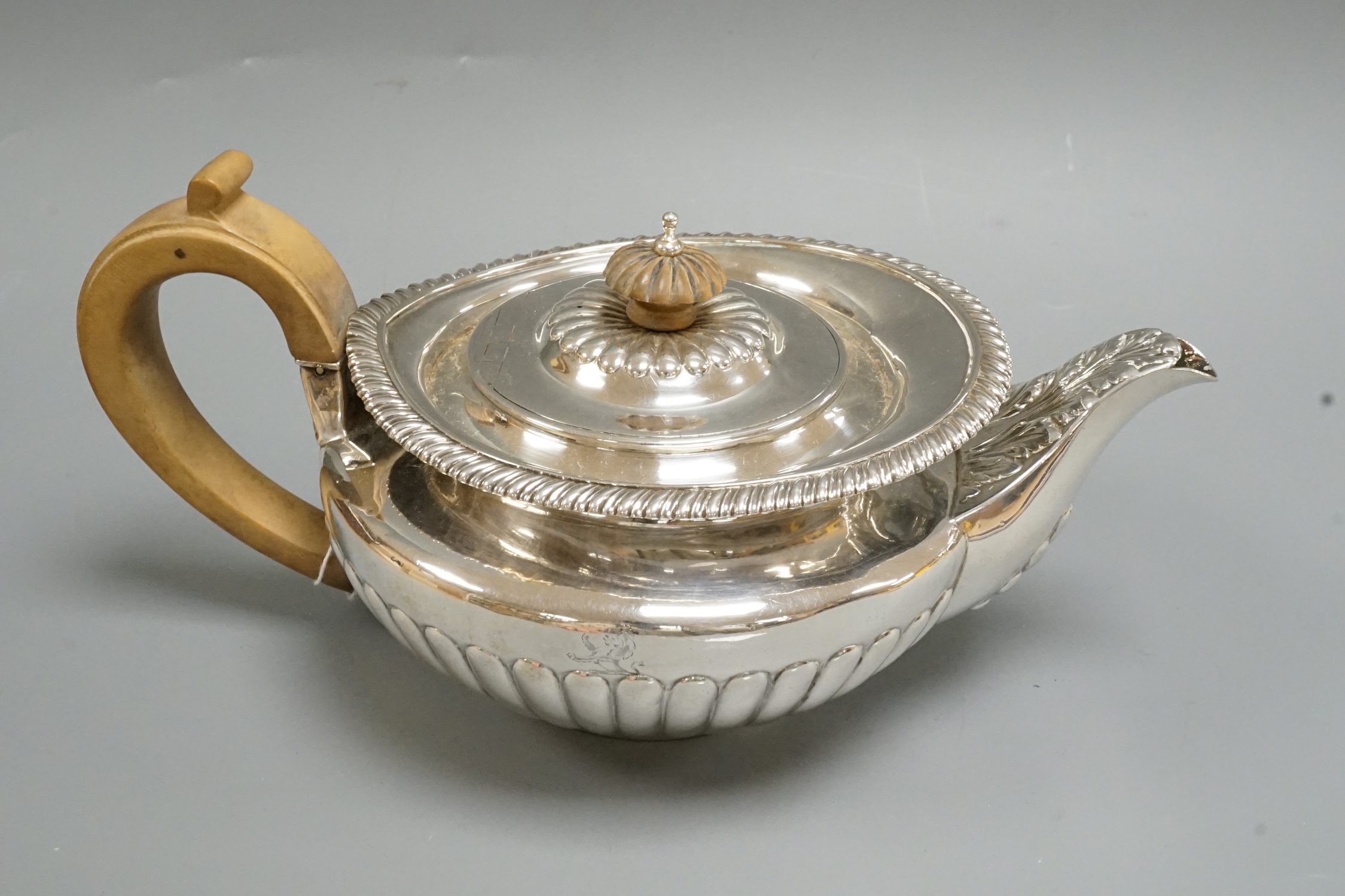 A George IV demi fluted silver teapot, Emes & Barnard, London, 1824, gross weight 20.6oz.                                                                                                                                   