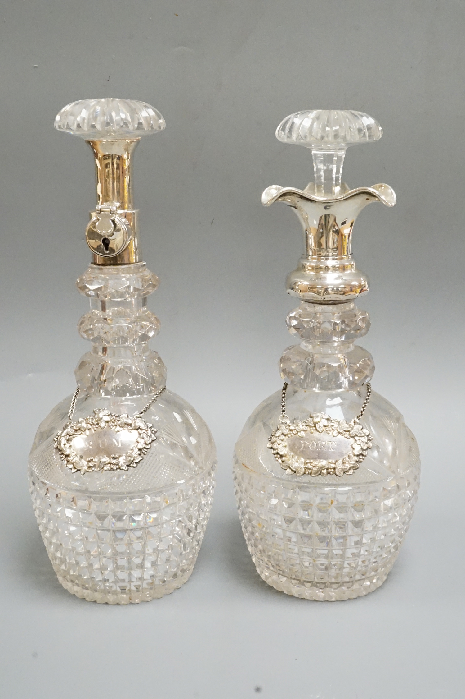 A near pair of George V silver mounted cut glass decanters and stoppers, by Hukin & Heath, Birmingham, 1922, approx. 30.7cm.                                                                                                
