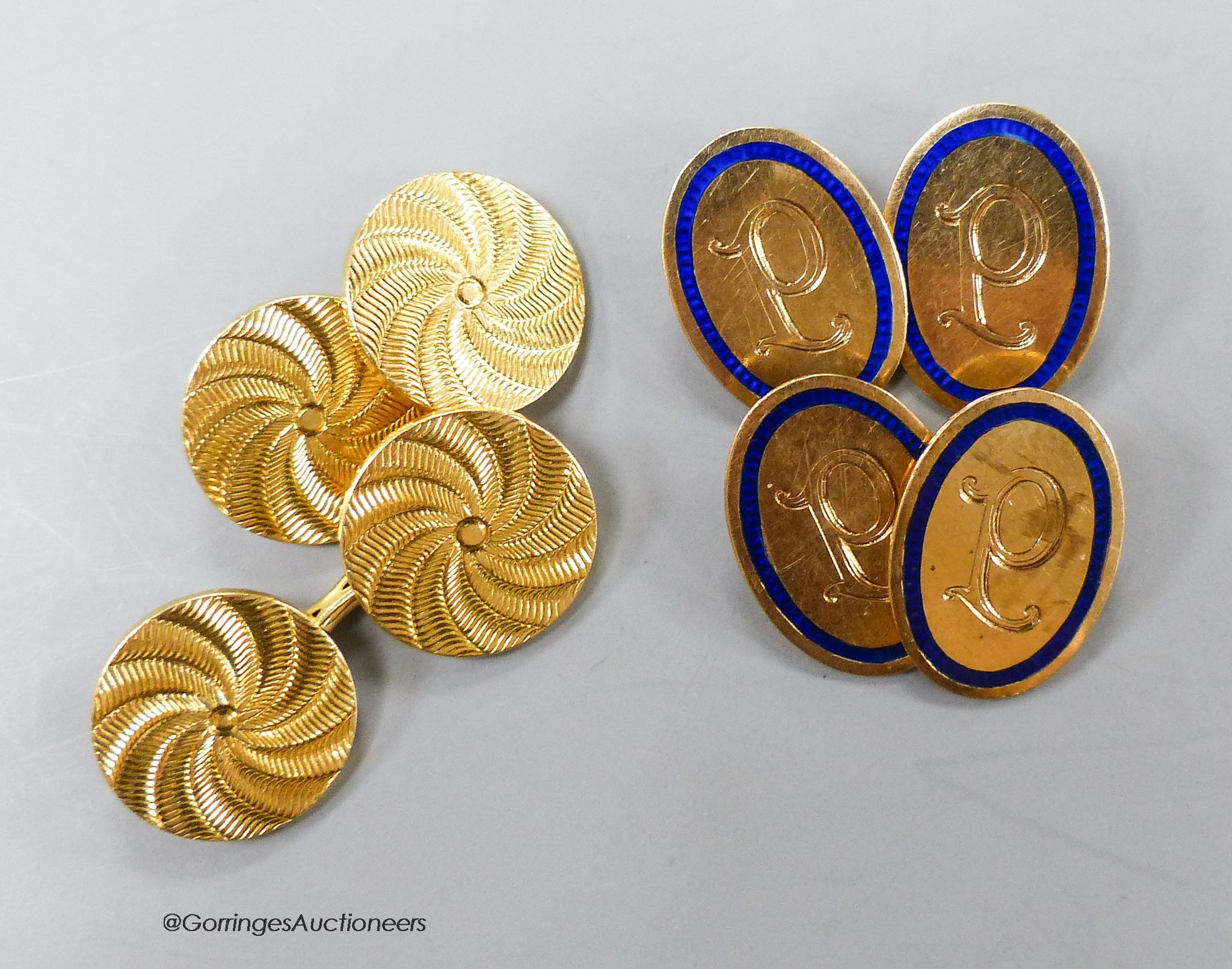 A pair of George V 9ct gold and blue enamel oval cufflinks, with engraved initial, gross 6.6 grams and one other pair of yellow metal disc cufflinks, 12.9 grams.                                                           