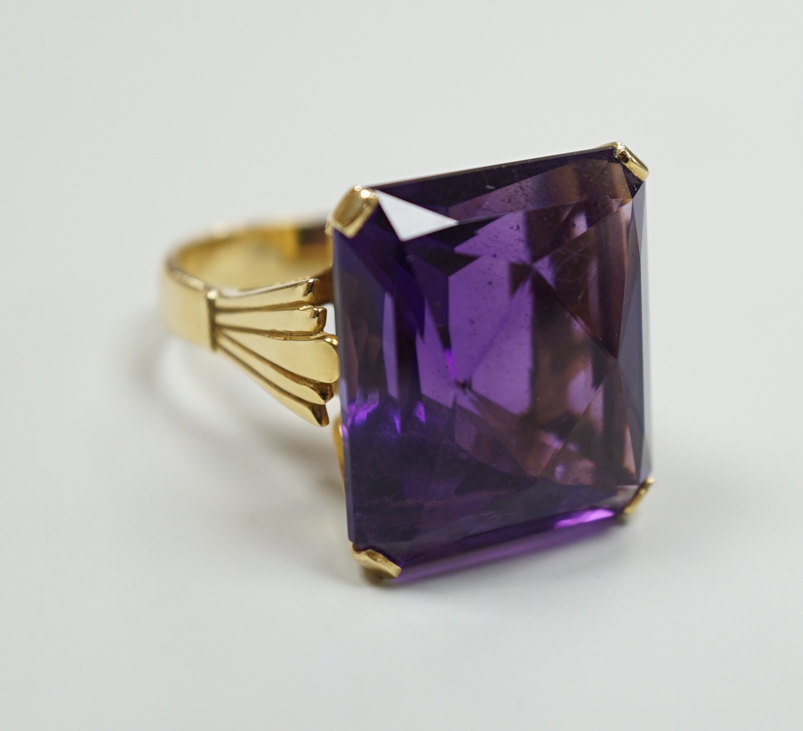 A large modern 18ct gold and fancy rectangular cut single stone amethyst set dress ring, size W, gross weight 22 grams                                                                                                      