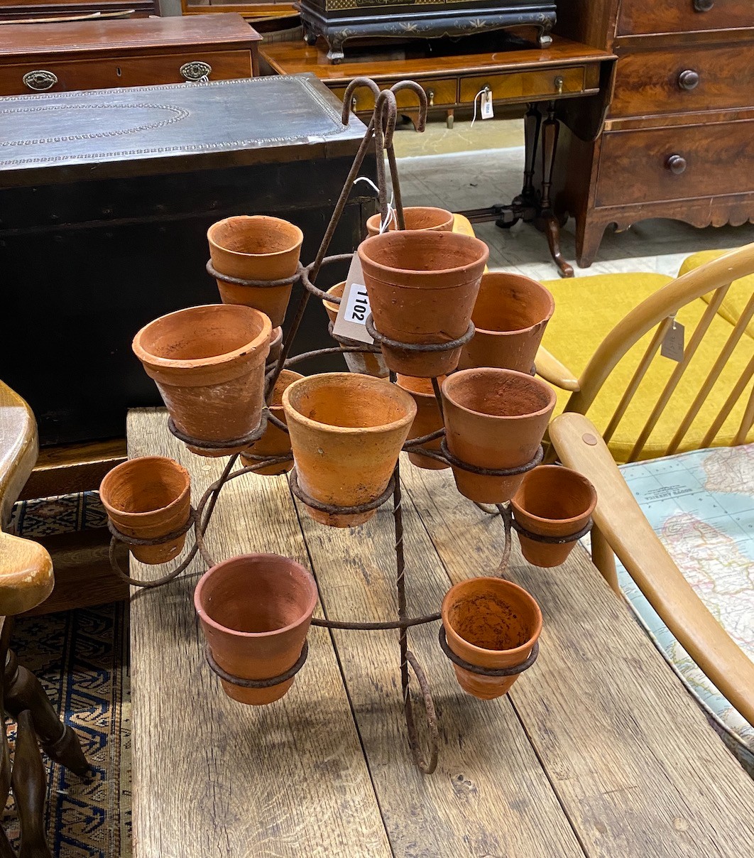Fifteen small terracotta pots on wrought iron stand, height 52cm                                                                                                                                                            