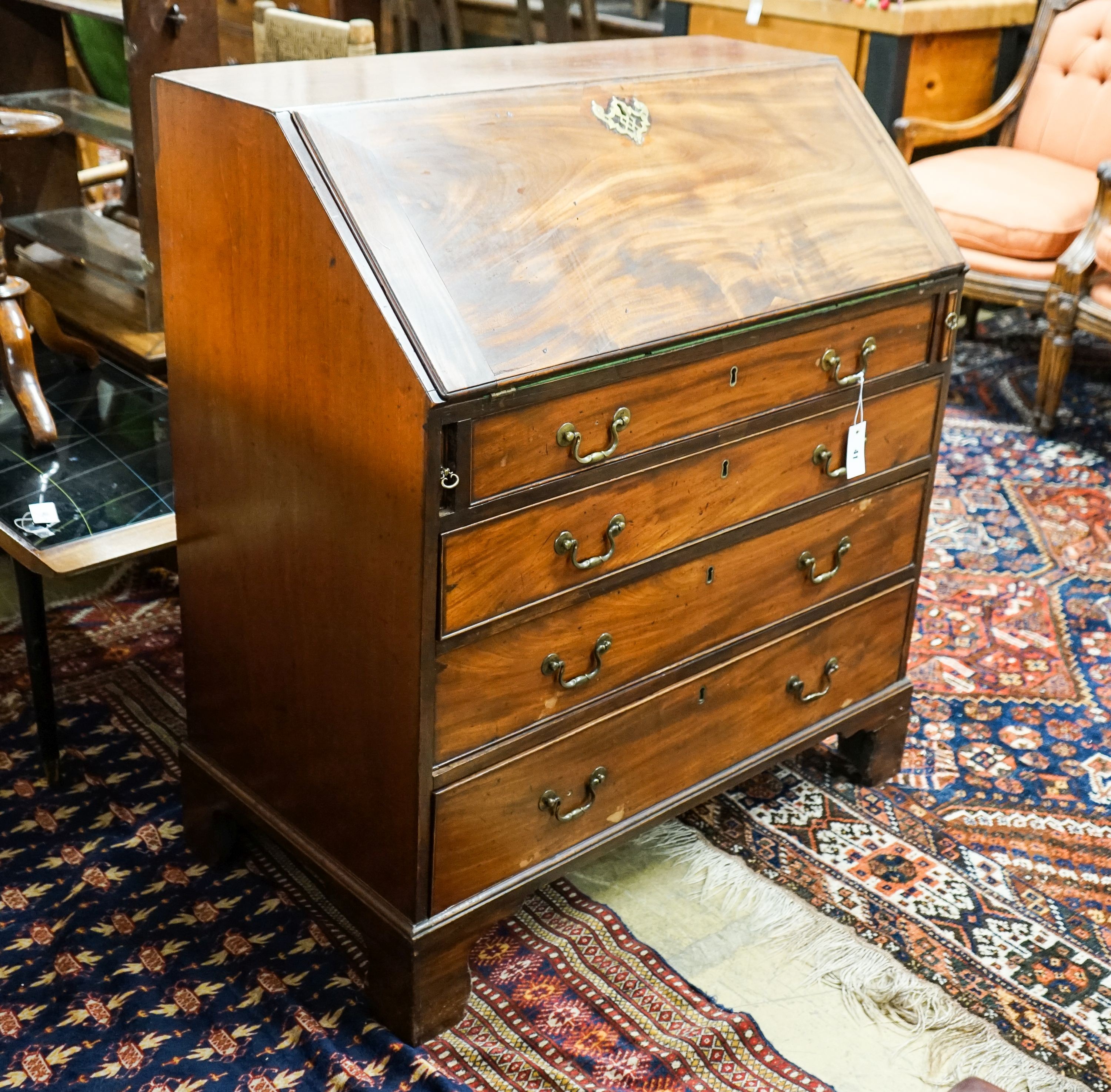 A George III mahogany bureau, with fall front and four drawers, width 91cm, depth 50cm, height 102cm                                                                                                                        