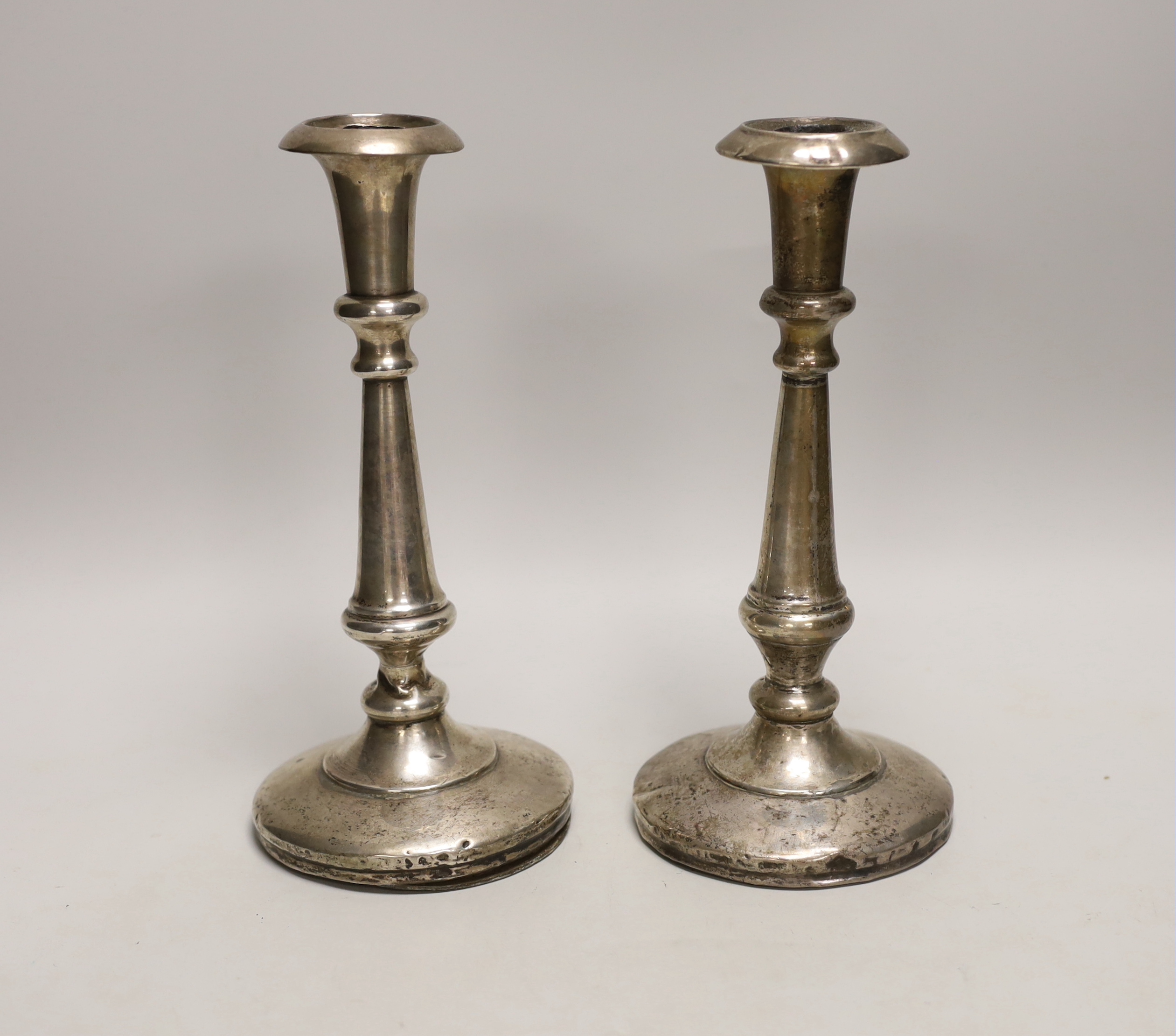 A pair of George V silver candlesticks (a.f.), William Neale & Son, Birmingham, 1912, height 23.5cm, weighted.                                                                                                              