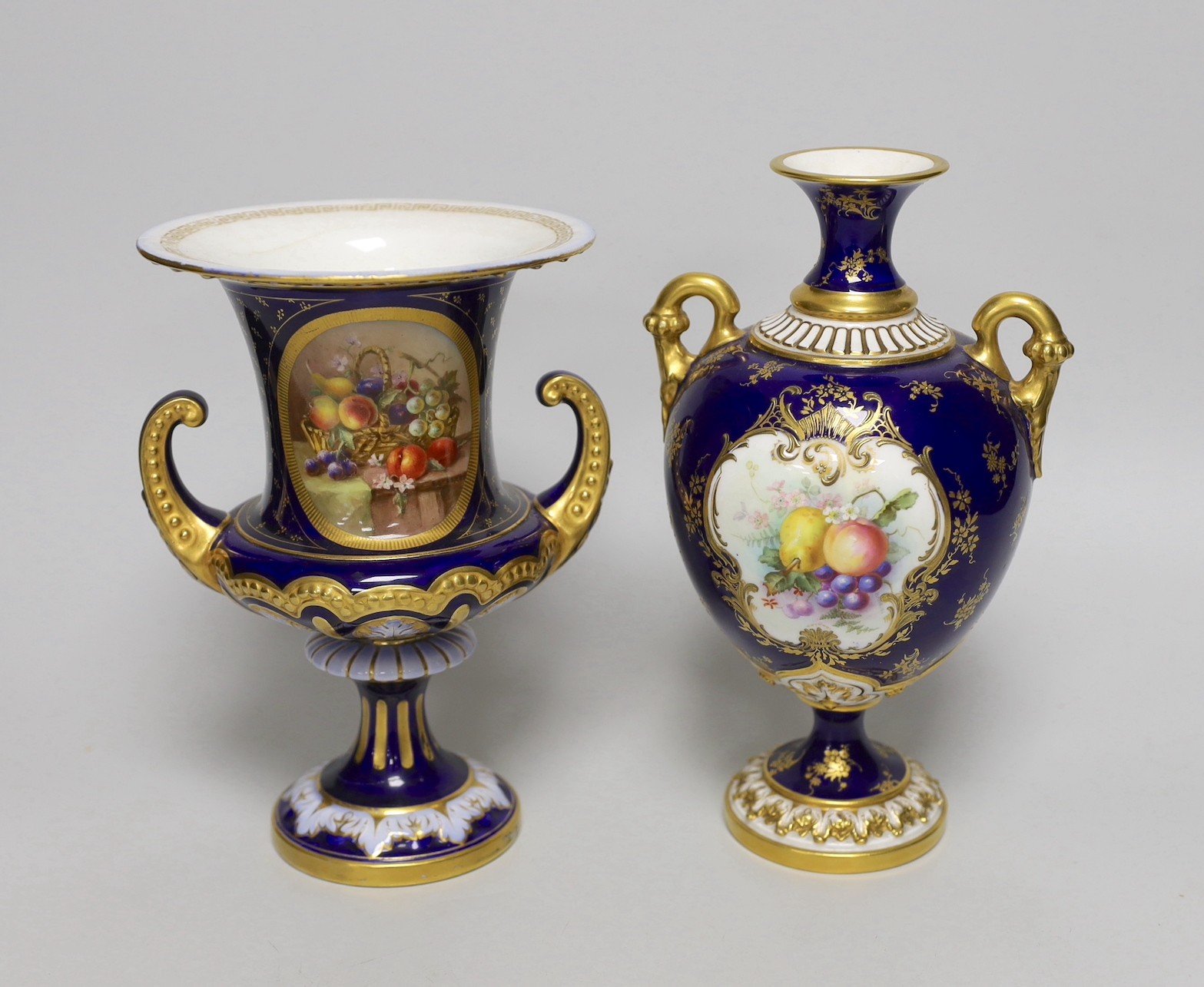 A Royal Worcester two handled vase with fruit on a blue ground by Hawkins, signed, marked LEADLESS GLAZE, date code 1901 together with a Royal Worcester vase, painted by Sebright, signed, date code 1913 (later a/f). Tall