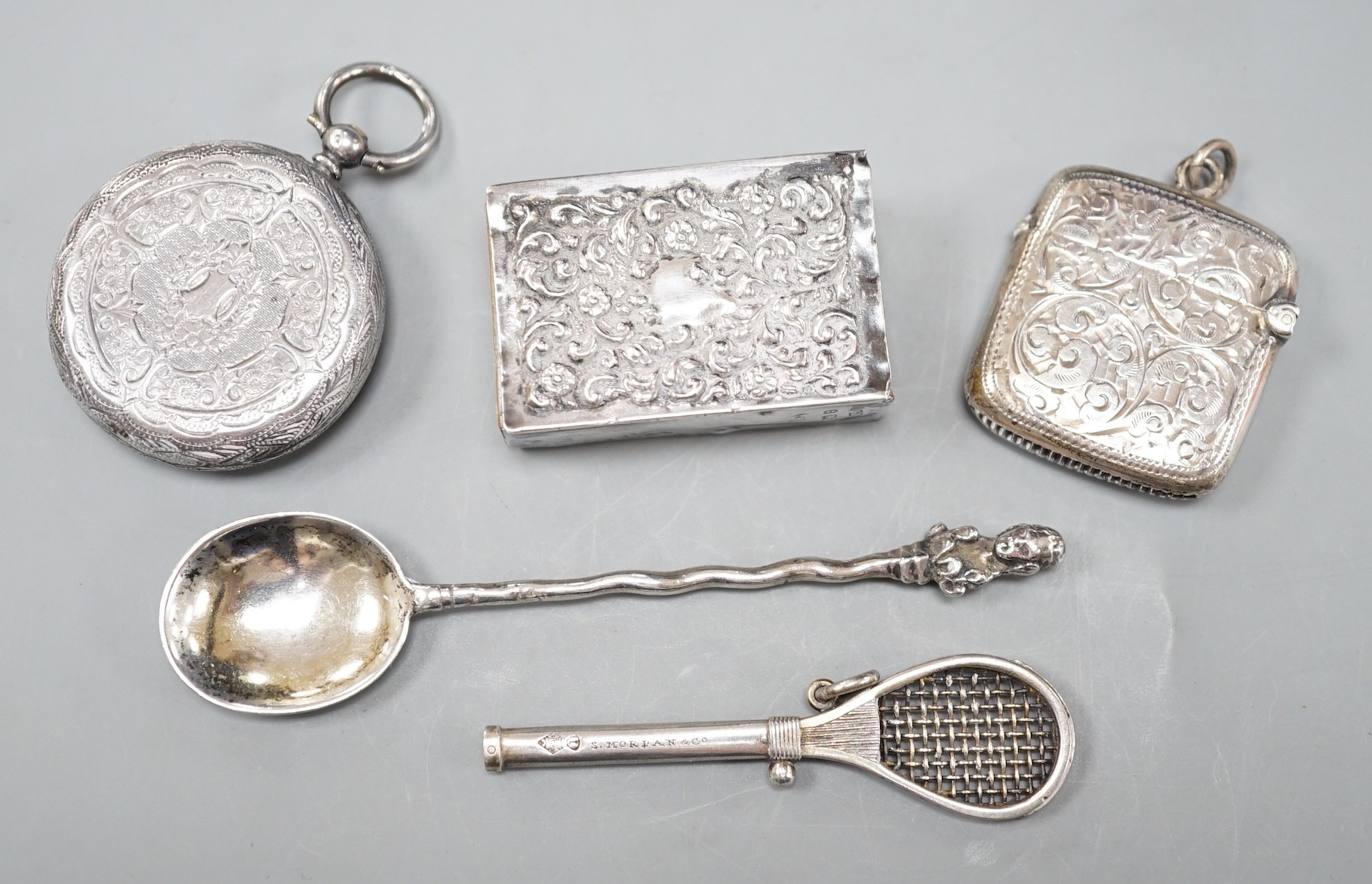 A late Victorian novelty white metal propelling pencil, modelled as a tennis racket, by Sampson Mordan & Co, 64mm, together with a watch case, silver vesta case, spoon and silver matchbox sleeve.                         