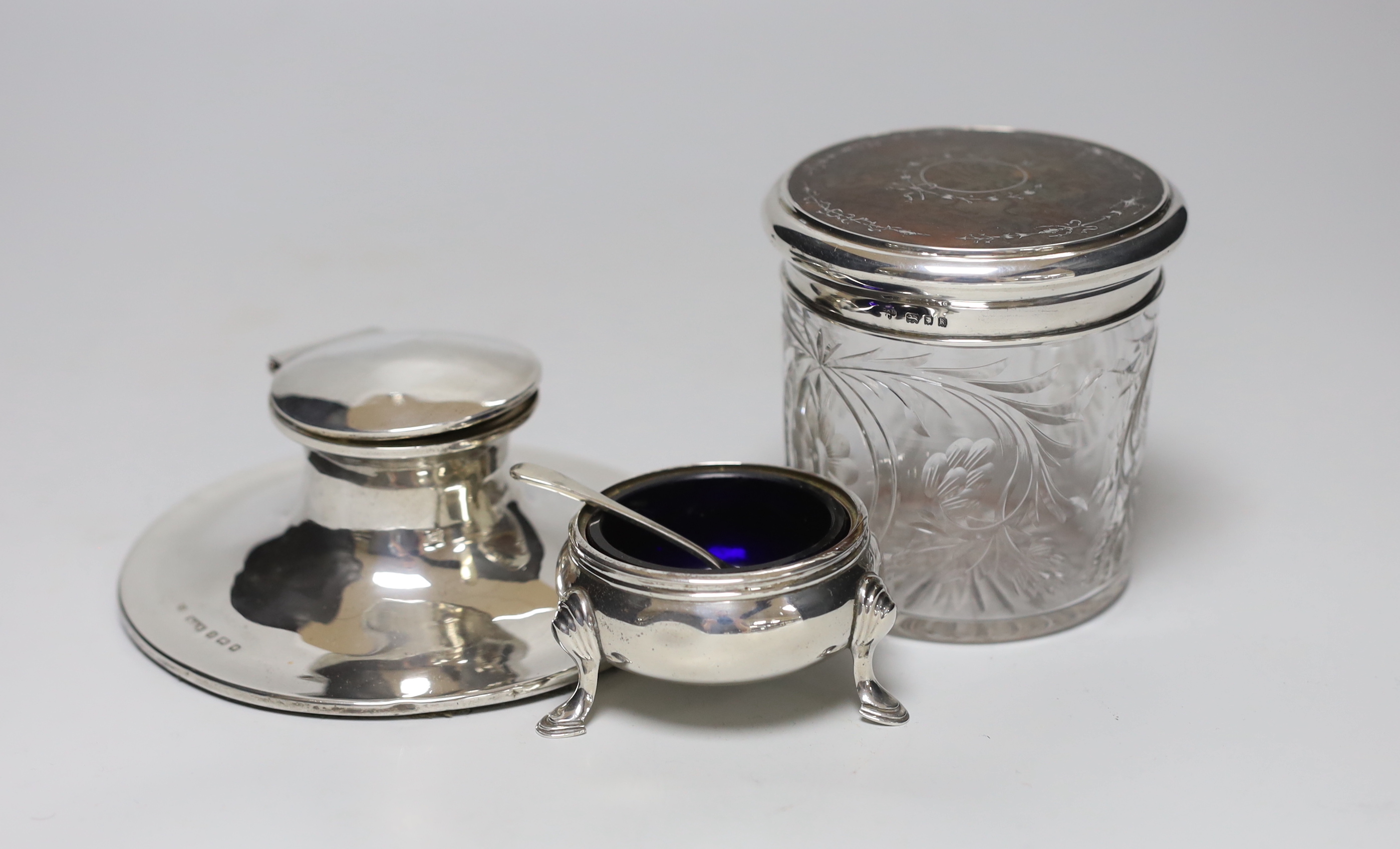 A George V silver and tortoiseshell pique lidded glass toilet jar, Charles & Richard Comyns, London, 1925, height 89mm, a silver mounted capstan inkwell and a silver salt and plated condiment spoon.                      
