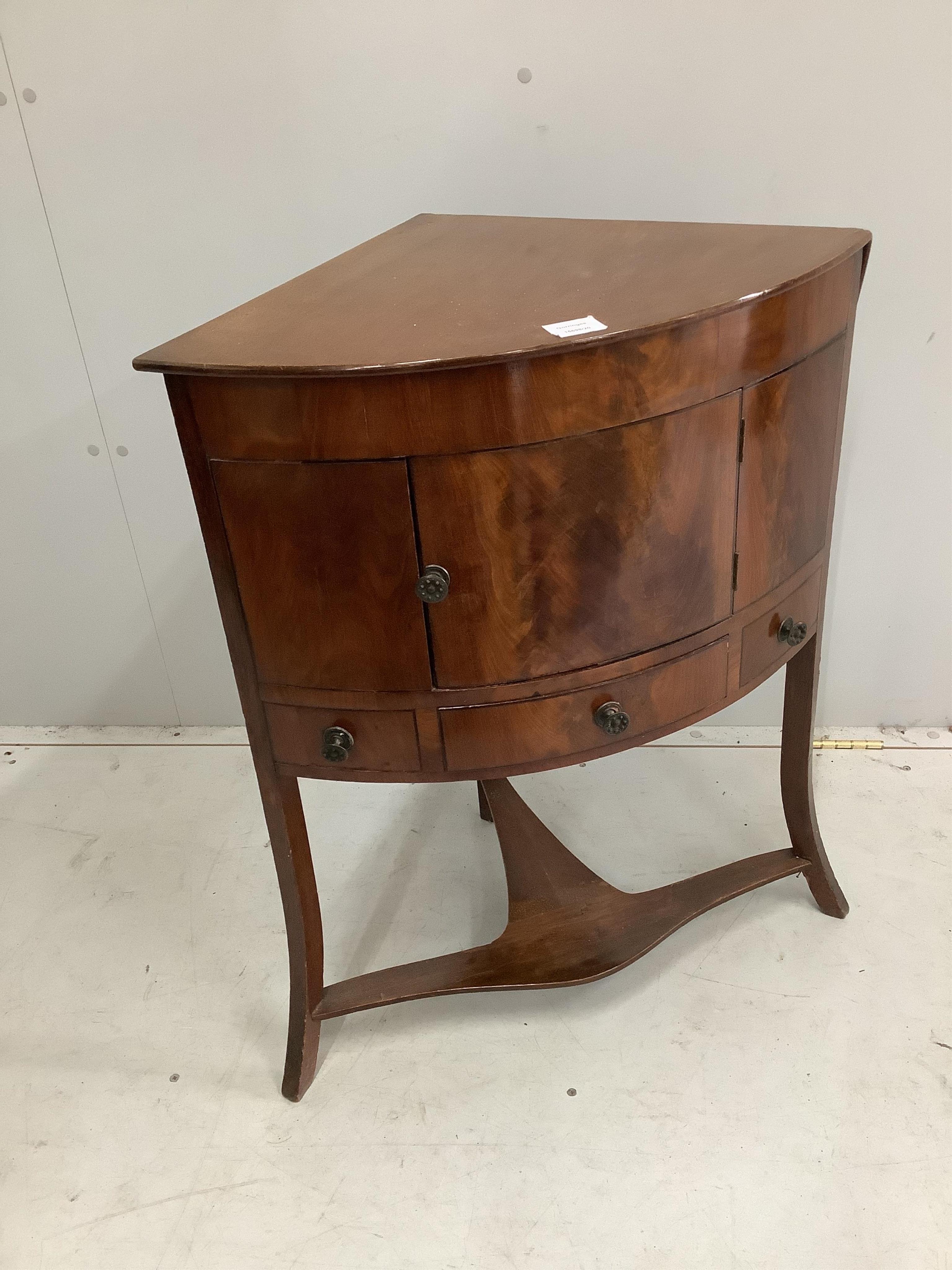 A George III mahogany corner washstand, width 64cm. Condition - fair to good                                                                                                                                                