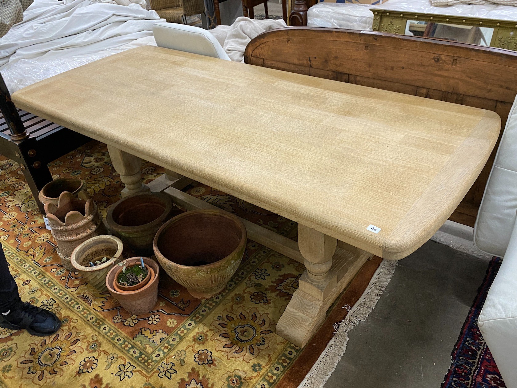 A rectangular bleached oak refectory dining table on four turned pillars with central stretcher, 210cm, width 89cm, height 75cm                                                                                             