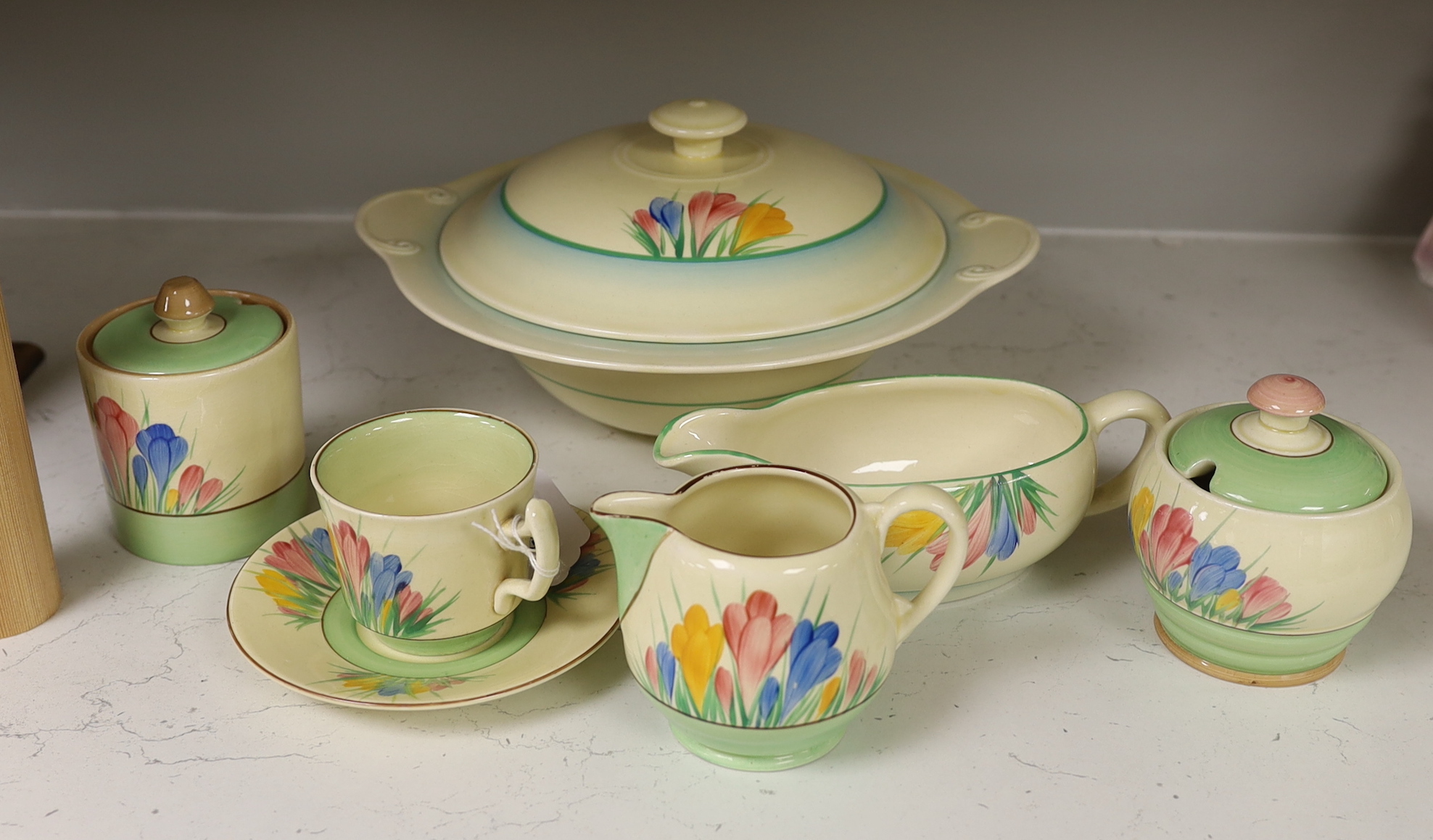 Clarice Cliff ‘Spring Crocus’: a tureen and cover, a cup and saucer, two jam pots, a sauce boat and cream jug (7)                                                                                                           