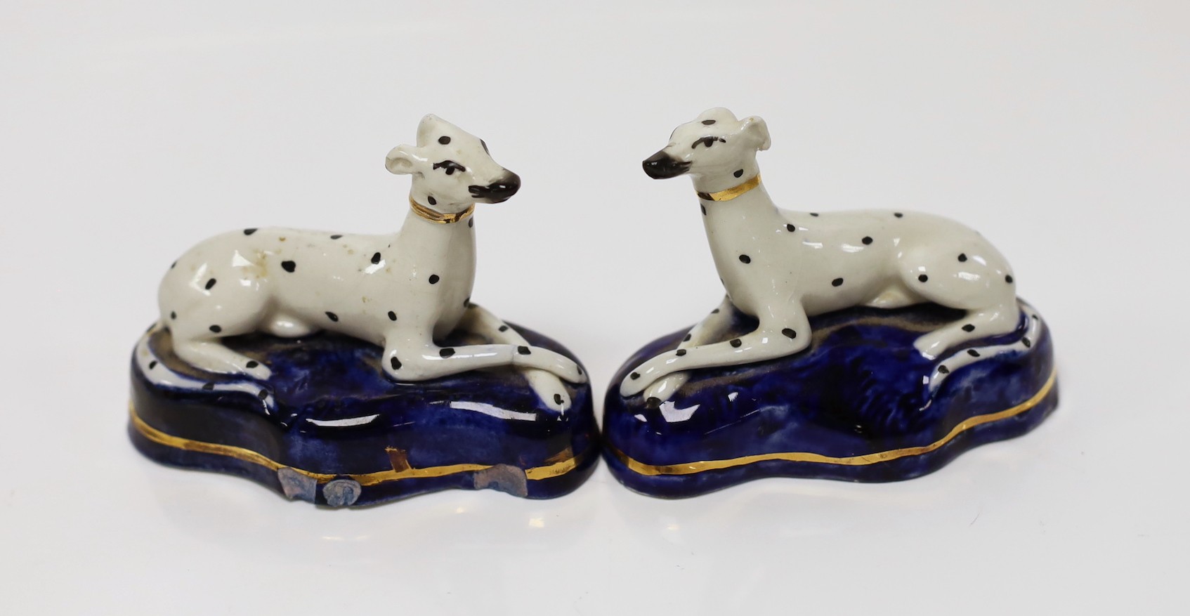 A pair of Staffordshire porcelain dalmations, c.1840, 9.5cms wide                                                                                                                                                           