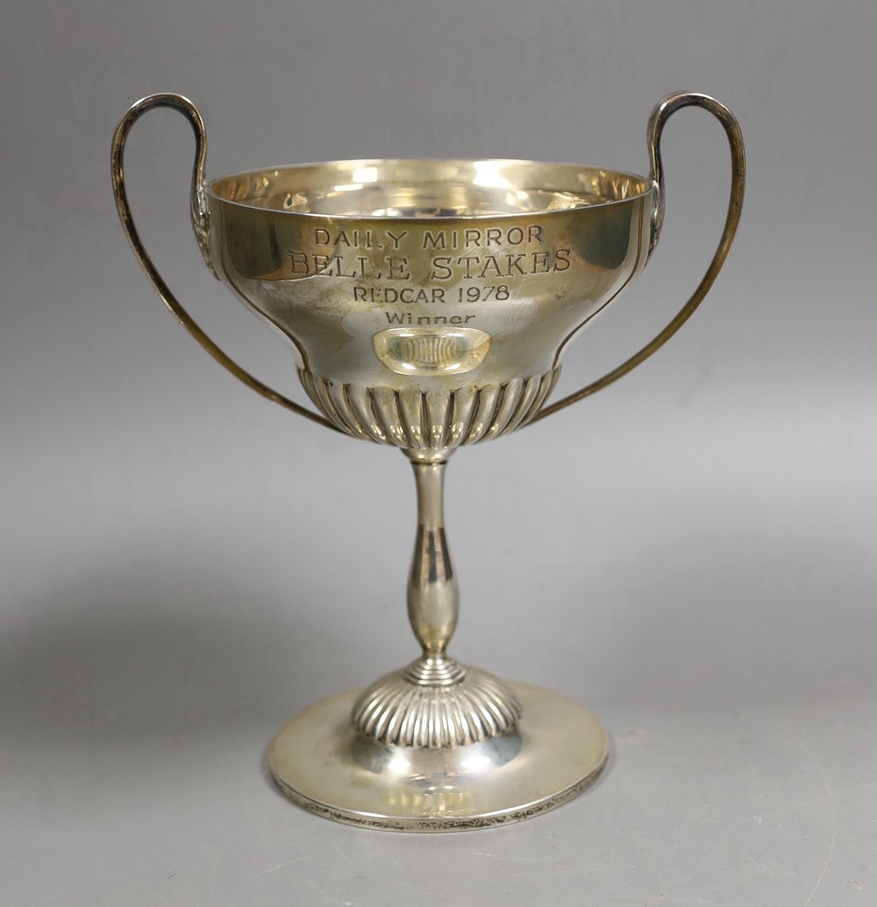 An Edwardian demi fluted silver two handled trophy cup, by Mappin & Webb, Sheffield, 1901, with later engraved horse racing inscription, height 20.1cm, 13.6oz.                                                             