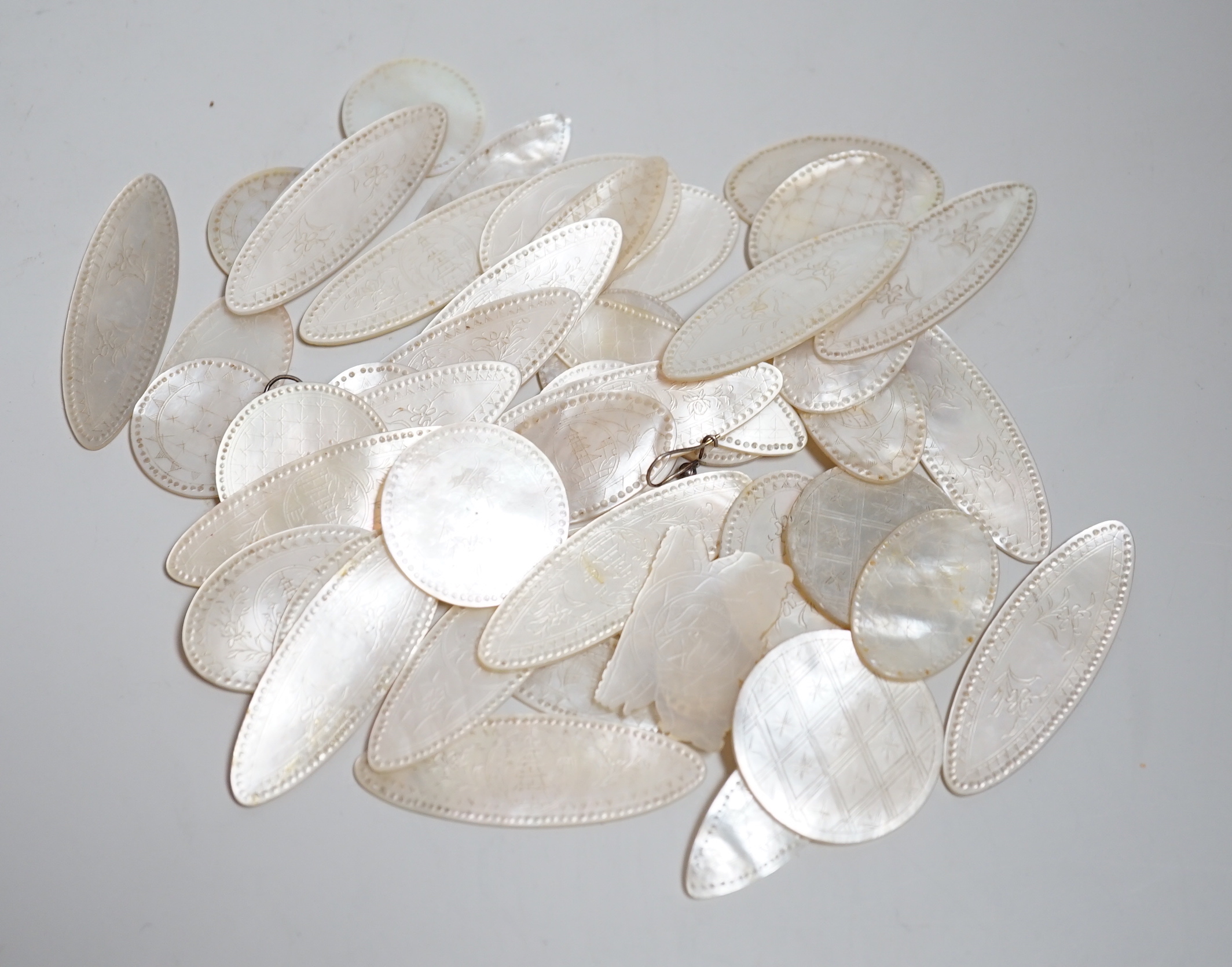 A collection of Chinese mother of pearl counters or tokens including two converted to drop earrings, the largest 5cm wide                                                                                                   