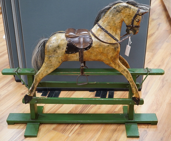 An early 20th century small dapple grey rocking horse, 92cm high, 112cm long. Condition - fair                                                                                                                              