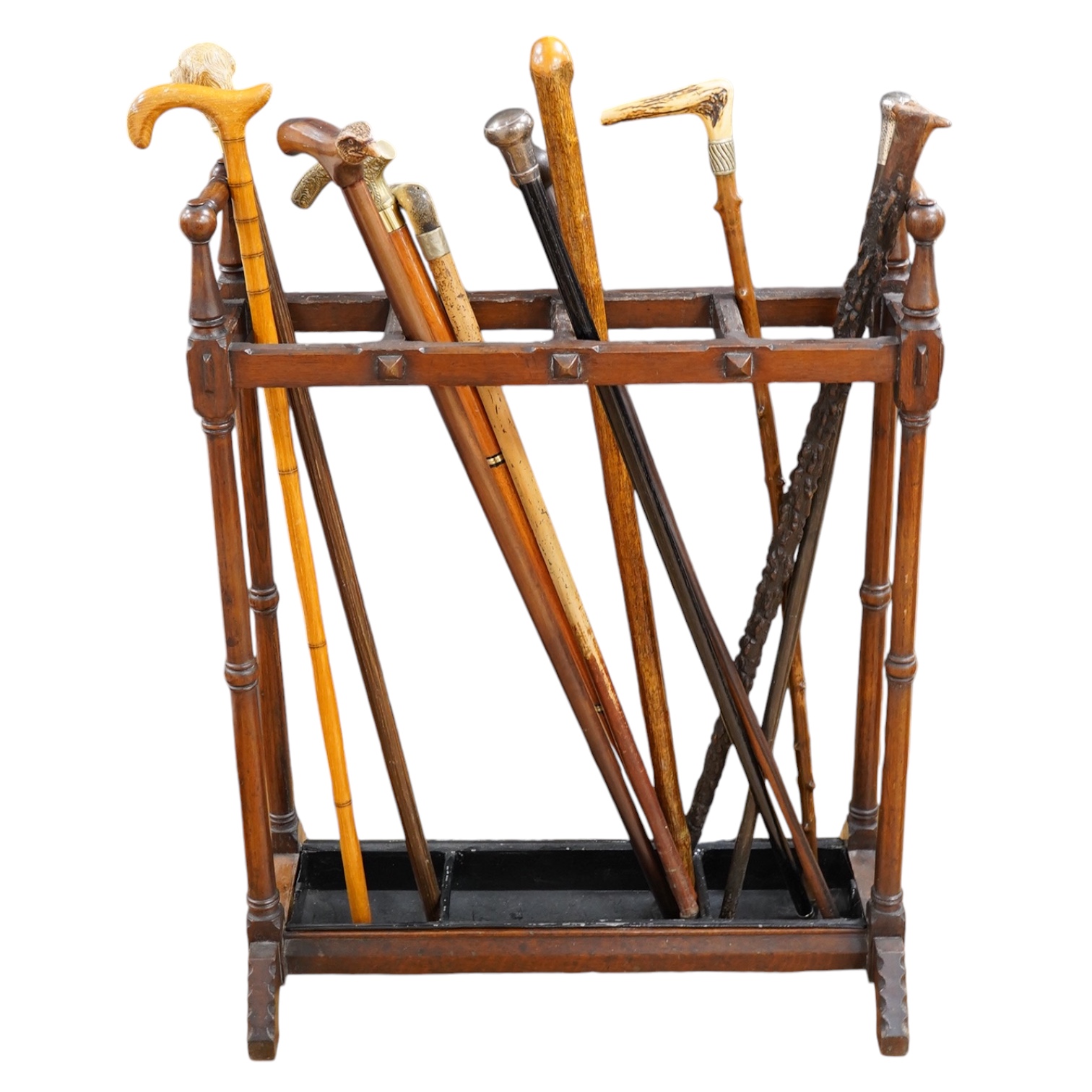 An Arts & Crafts oak umbrella stand and various walking sticks including two silver mounted. Condition - varies                                                                                                             