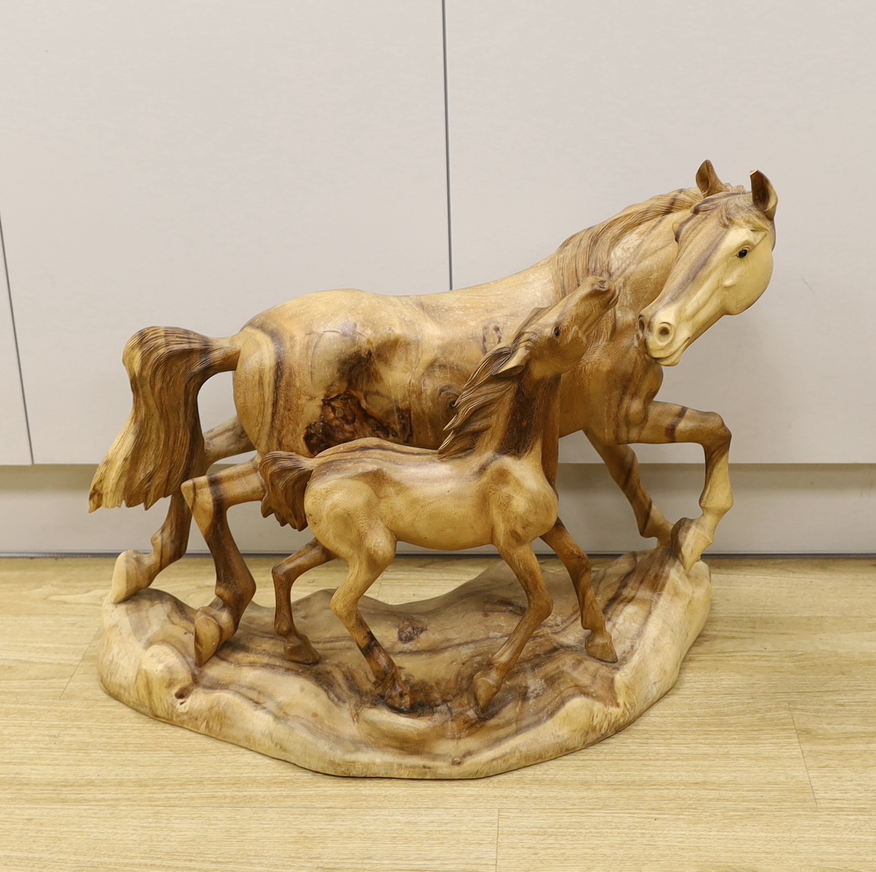 A large wooden carving of a horse and foal, 70cm wide                                                                                                                                                                       