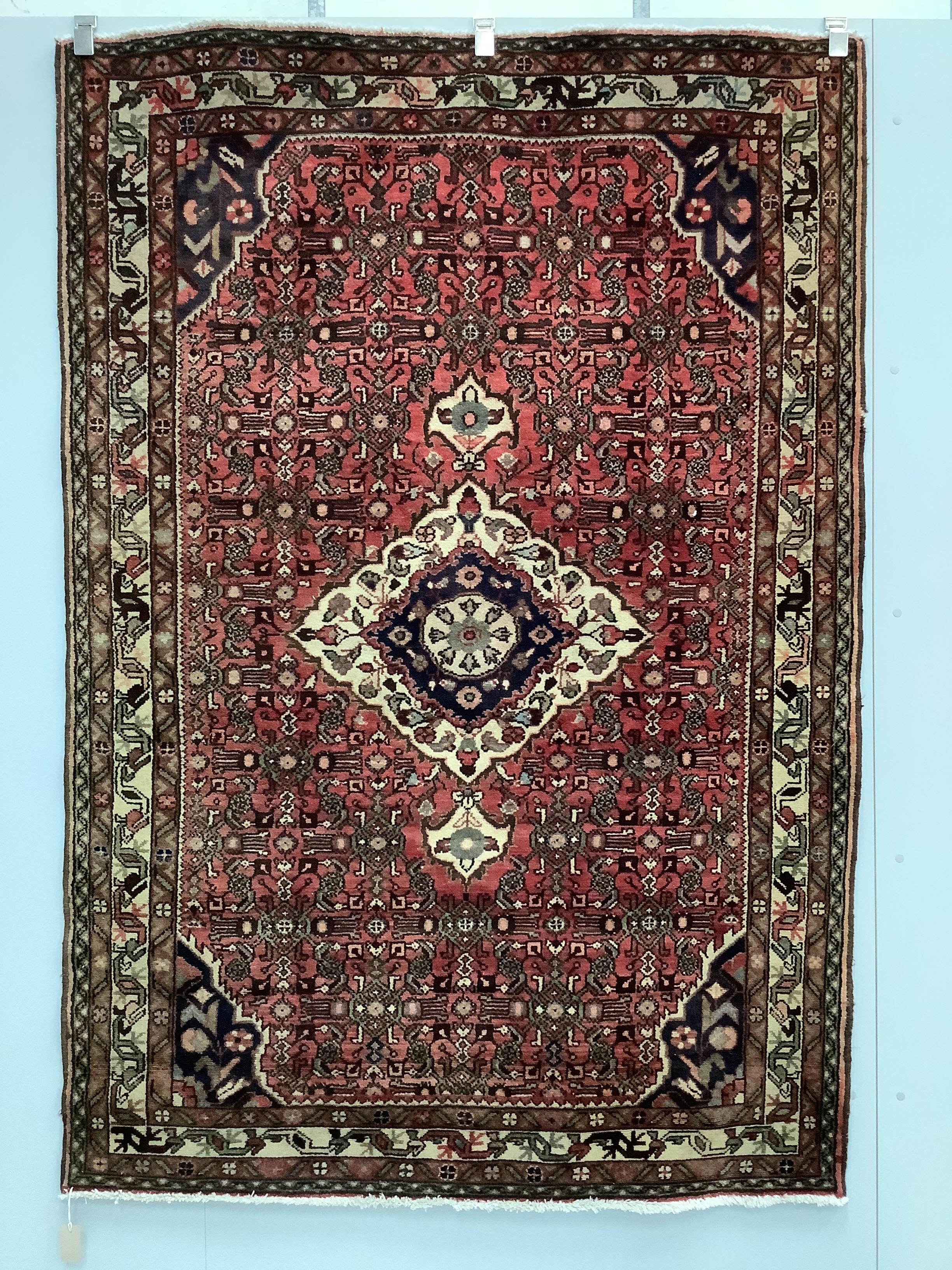 A North West Persian red ground rug, 206 x 141cm                                                                                                                                                                            