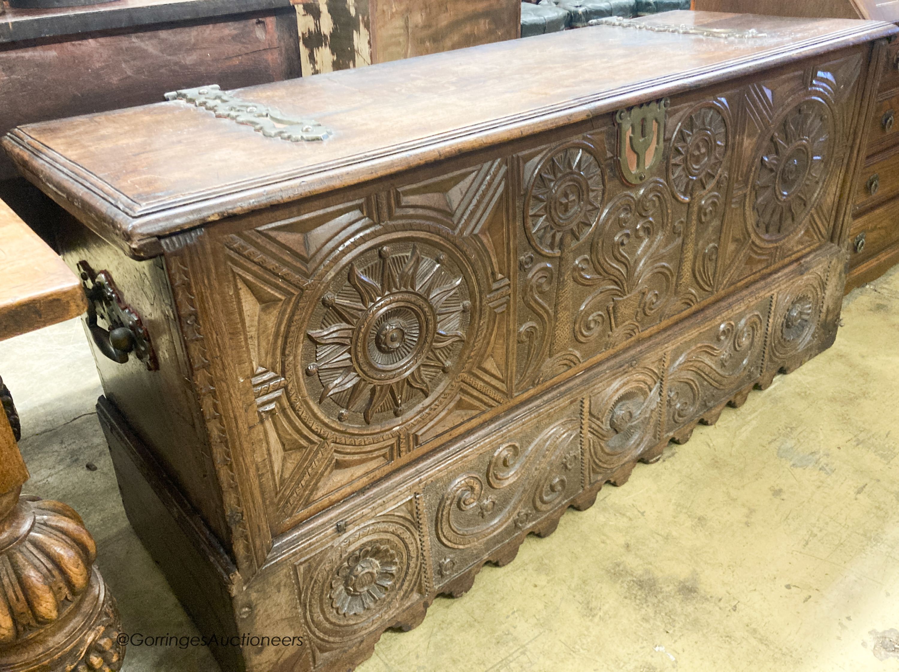 A 17th / 18th century Welsh oak coffer, with carved panelled front and heavy brass strap hinges, W.162cm D.57cm H.78cm                                                                                                      