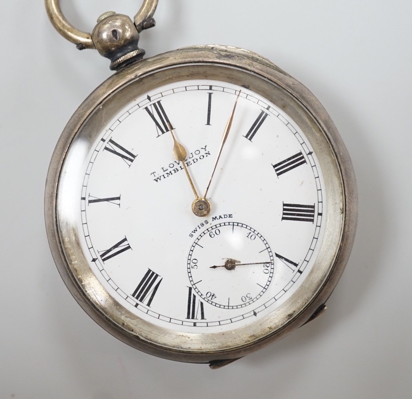A Swiss open faced keywind pocket watch, retailed by Lovejoy, Wimbledon, with Roman dial and key.                                                                                                                           