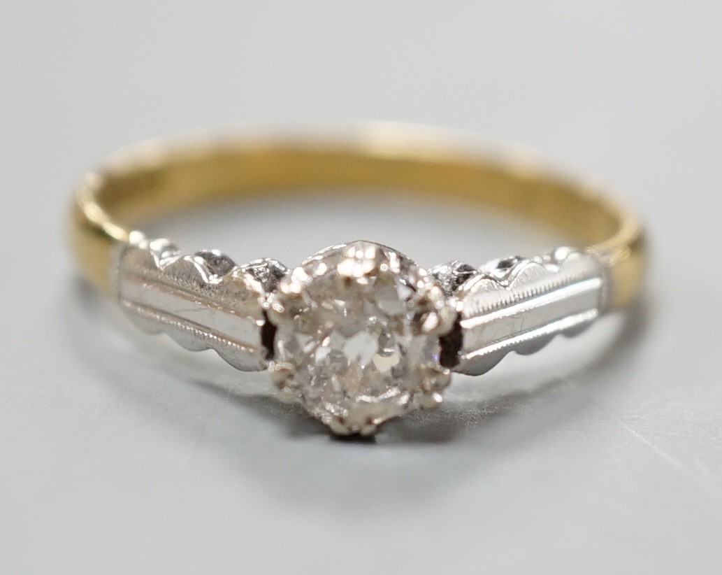 A modern 18ct gold and solitaire diamond ring, size M, gross weight 2.7 grams.                                                                                                                                              