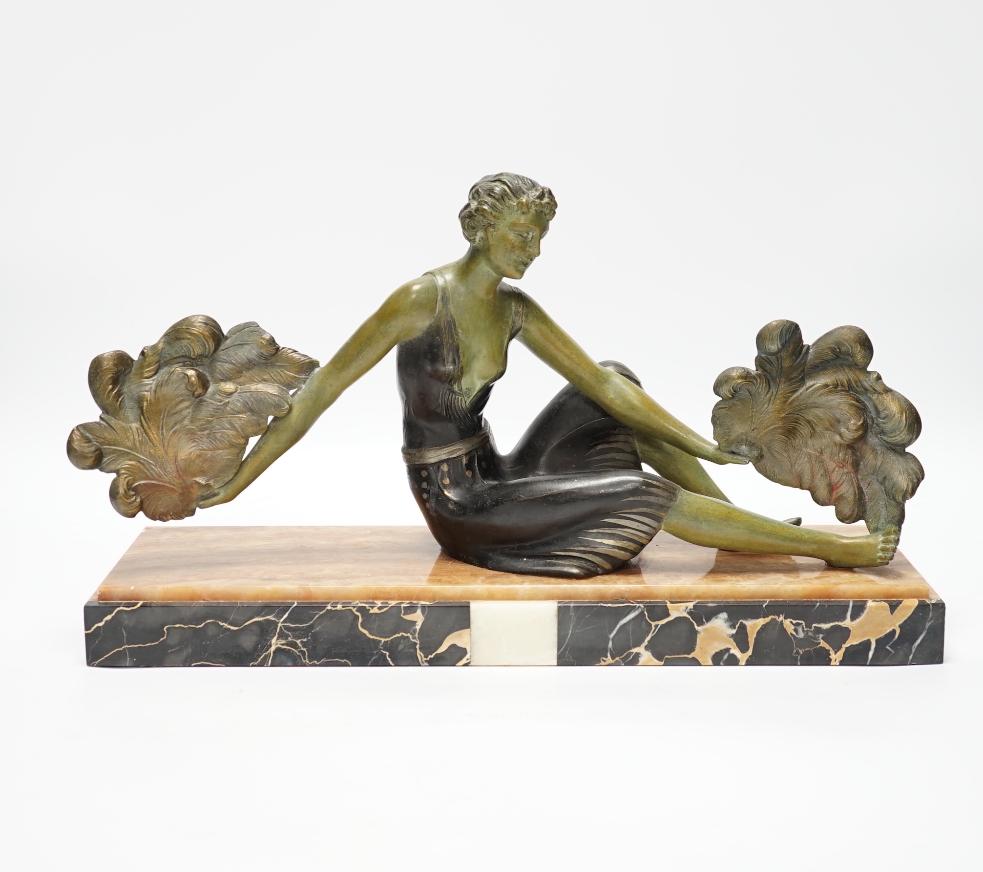 An Art Deco patinated spelter and marble figure, signed A. Leclerc, 40cm wide                                                                                                                                               