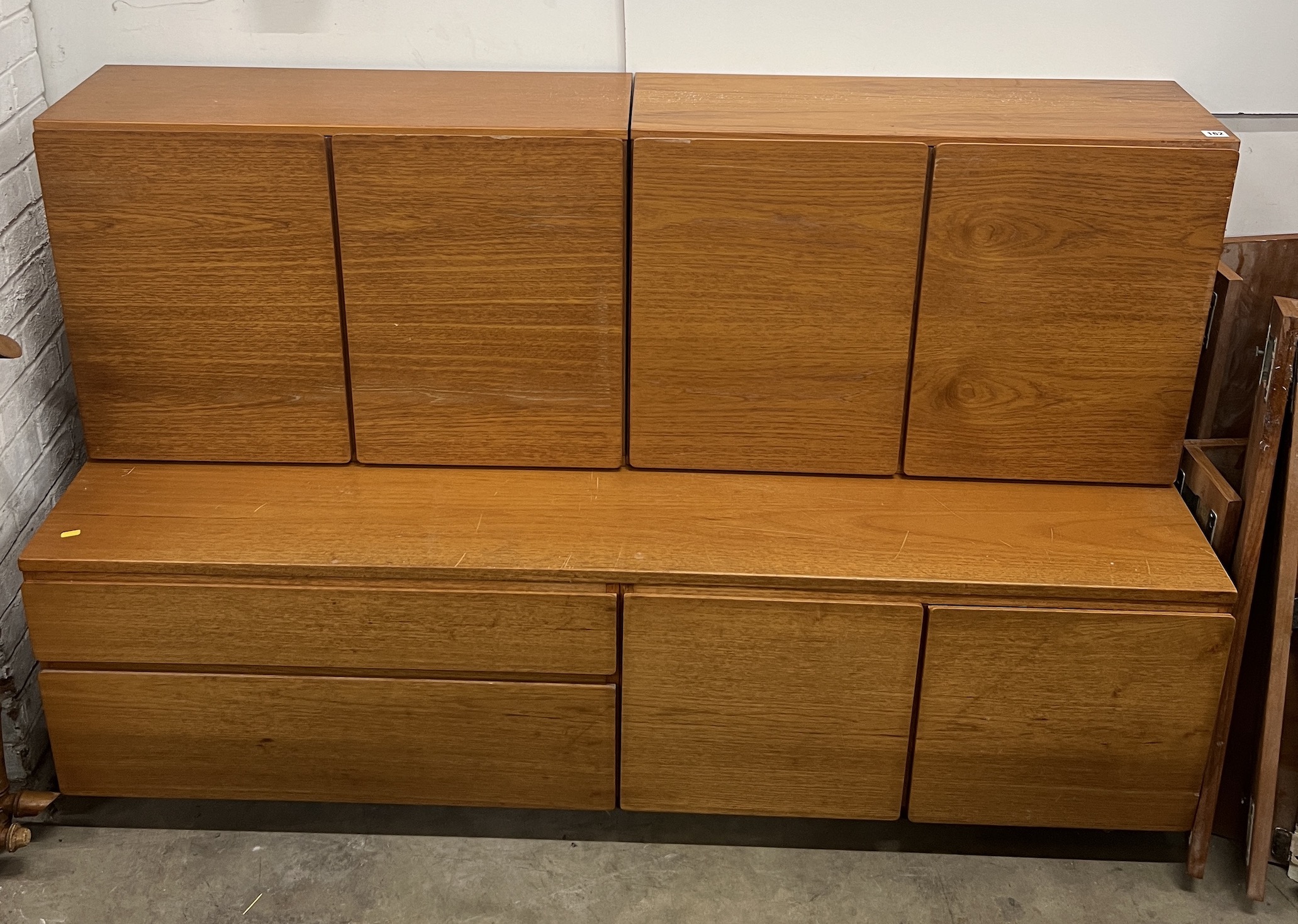 A mid century teak side cabinet width 168cm, depth 53cm, height 108cm, a similar glazed side cabinet and a ladder system bookcase.                                                                                          