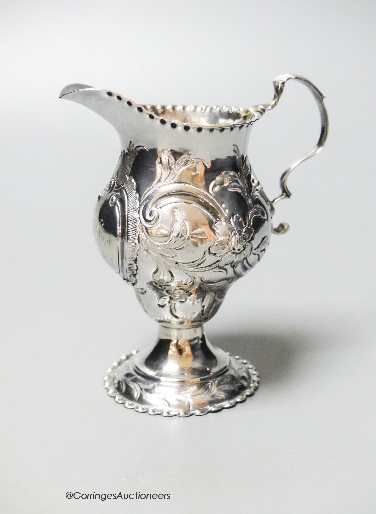 A George III silver helmet cream jug, with later embossed decoration, London, 1778, 10.6cm, 83 grams.                                                                                                                       