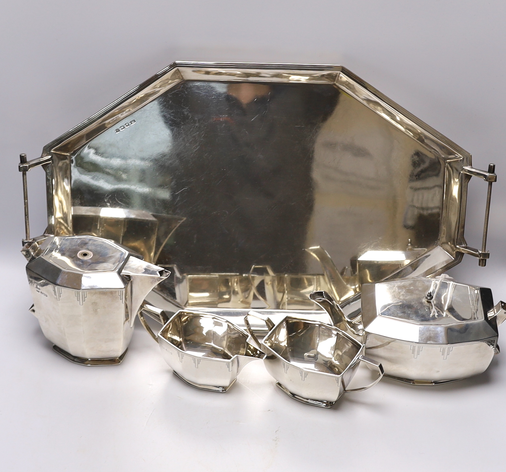 A George V Art Deco silver four piece tea set with tea tray, by Viners Ltd, Sheffield, 1934/36, 114.5oz. (lacking handles)                                                                                                  