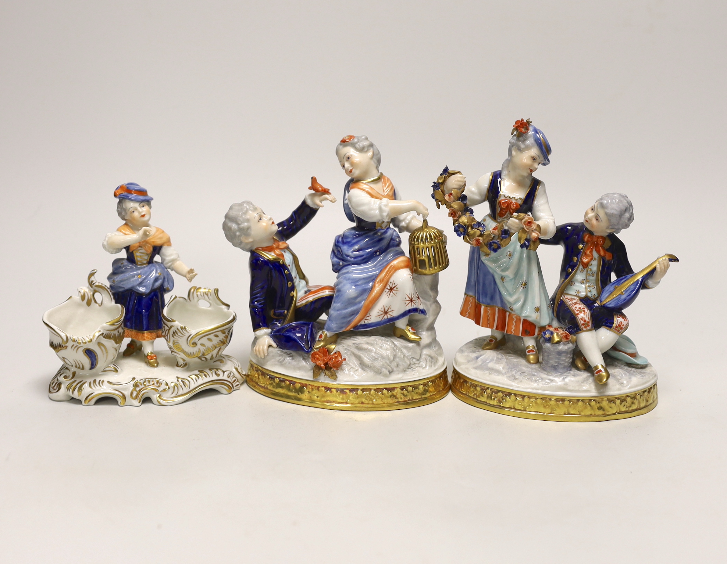 Two German porcelain figure groups and figural salt, tallest 17cms high                                                                                                                                                     