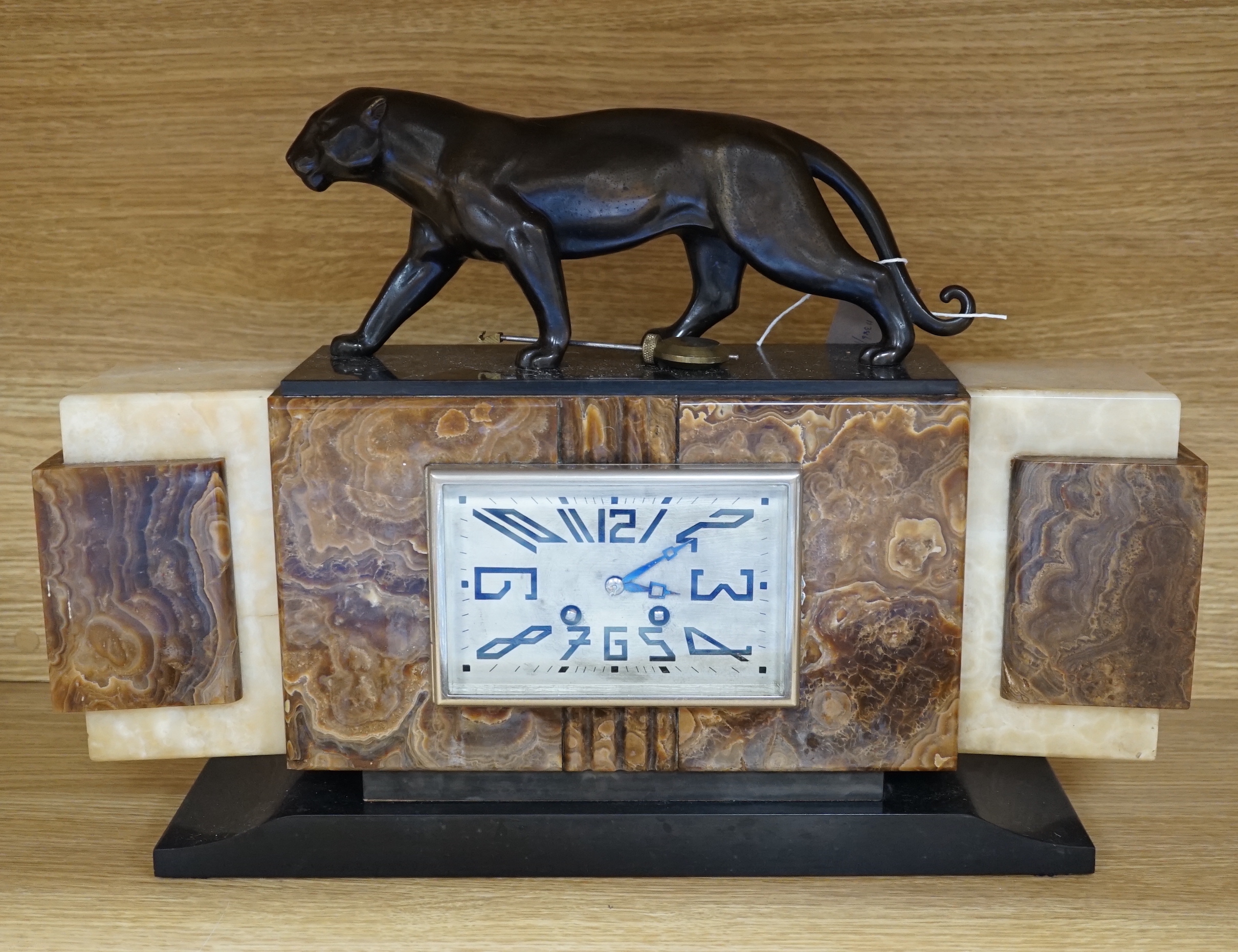 An Art Deco onyx and spelter mounted ‘panther’ mantel clock, 49.5cm wide                                                                                                                                                    