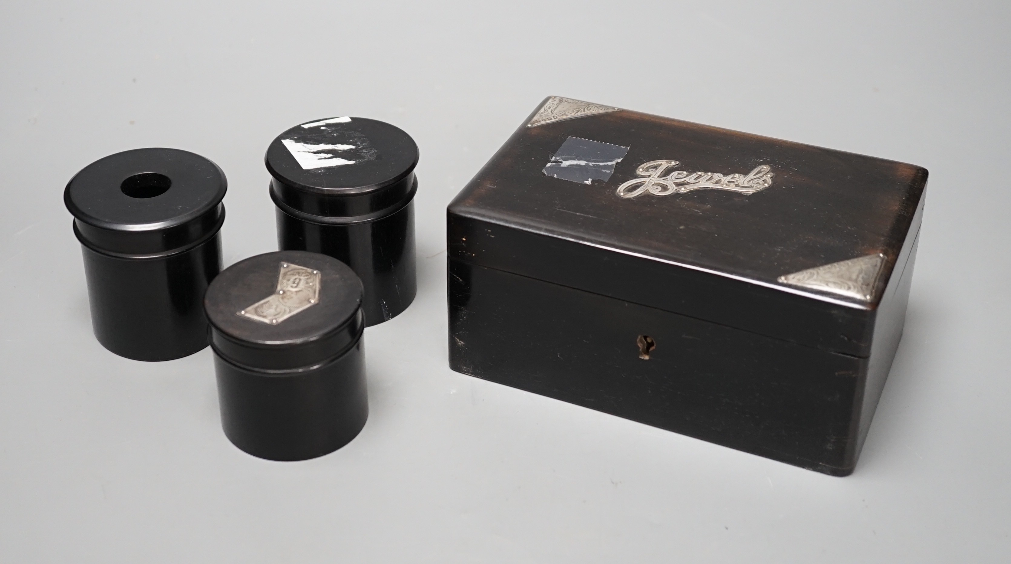 A Victorian silver mounted ebonised 'jewels' box and three jars                                                                                                                                                             