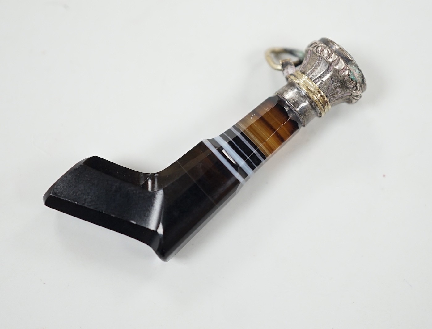 A 19th century white metal and bloodstone set novelty seal, modelled as a revolver, with banded agate handle, 43mm.                                                                                                         
