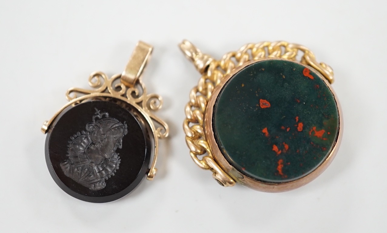 A late Victorian 9ct gold and bloodstone set spinning fob seal, 29mm and one other yellow metal and chalcedony set spinning fob seal.                                                                                       