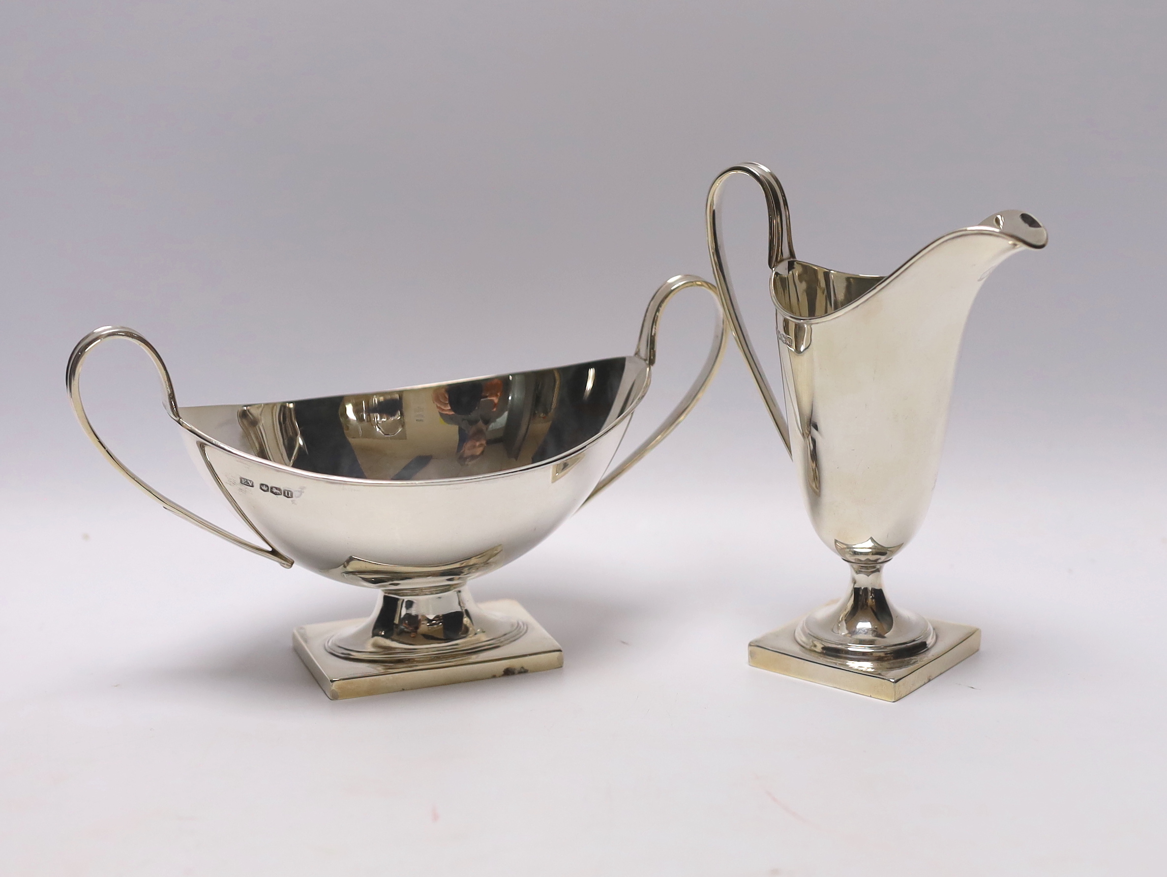 A George VI silver cream jug and two handled sauceboat by Viners Ltd, Sheffield, 1937, jug height 13.7cm, 8.3oz.                                                                                                            